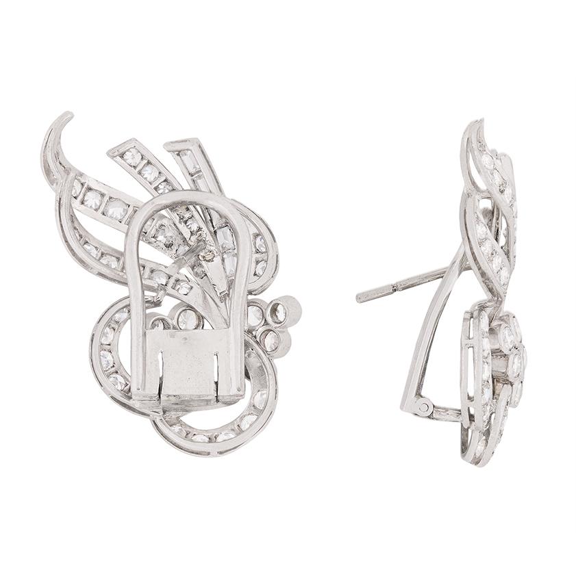Stunning, fabulous and exotic! These earrings date back to the 1920s and are a wonderful example of the high fashion dress earrings from the era. They feature a collection of baguette cut, transitional cut and eight-cut diamonds, with each earring