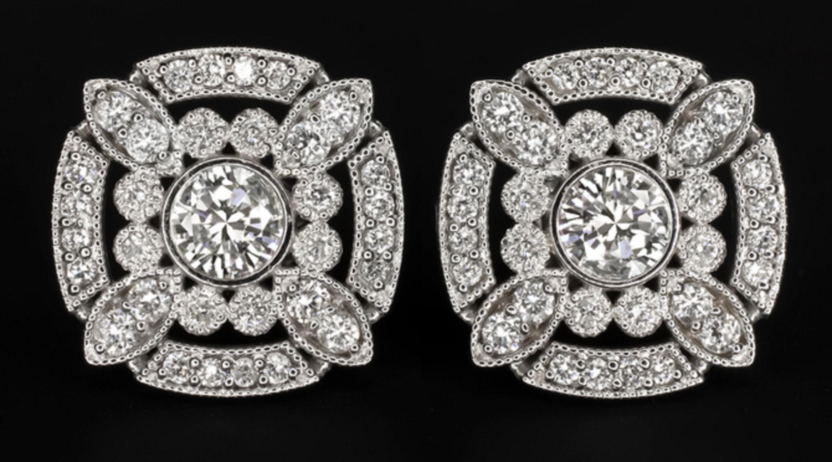 Magnificent stud earrings bring the glamour with a chic and sophisticated Art Deco style design! Featuring a vibrant half carat pair of round brilliant cut diamonds, the geometric double halo design glitters with an additional 0.40ct of vibrant pave
