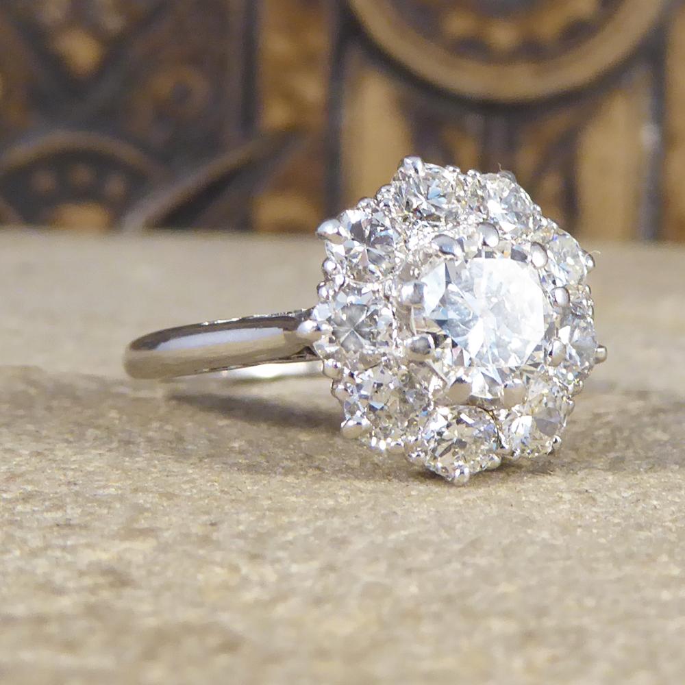 This gorgeous 1930's Diamond cluster ring features a 0.75ct centre stone with a eight diamonds surrounding it weighing just over 0.11ct each. So clear and bright this ring sparkles from every angle. Set in Platinum this ring is a quality Deco piece