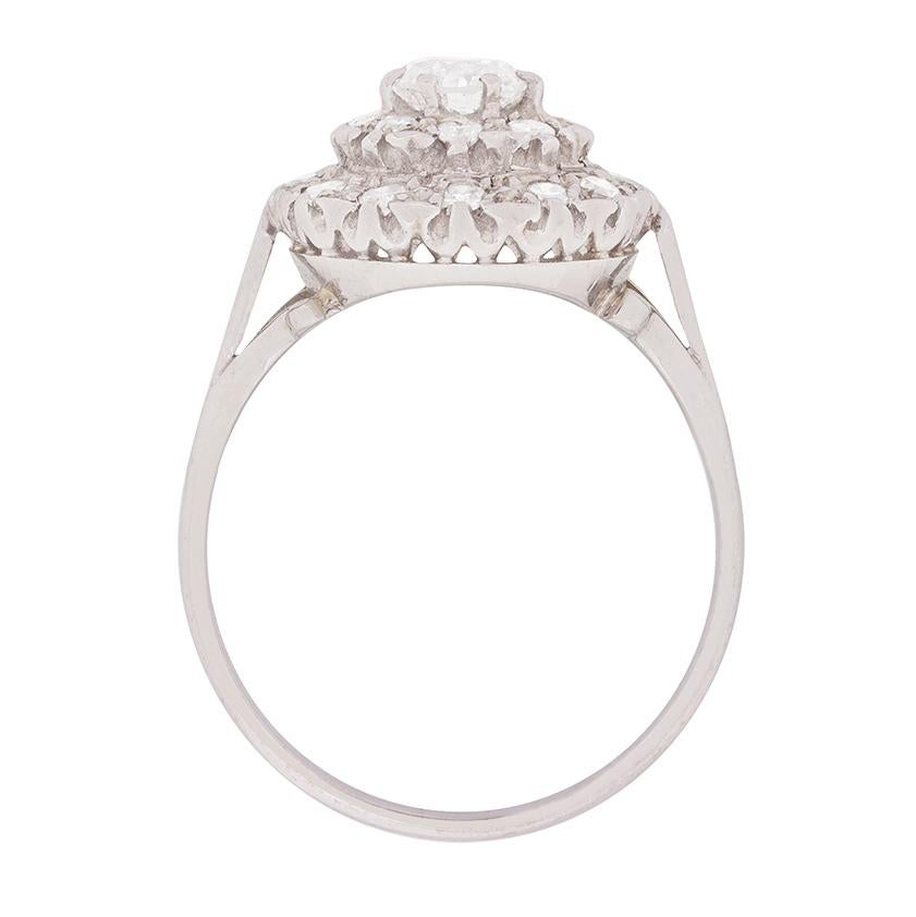 This beautiful cluster ring has a 0.50 carat centre stone which is an Old Cut. It is highlighted by eight cut diamonds totalling 0.40 carat and are grain set.

The centre stone is claw set in a handcrafted platinum band, which compliments the G