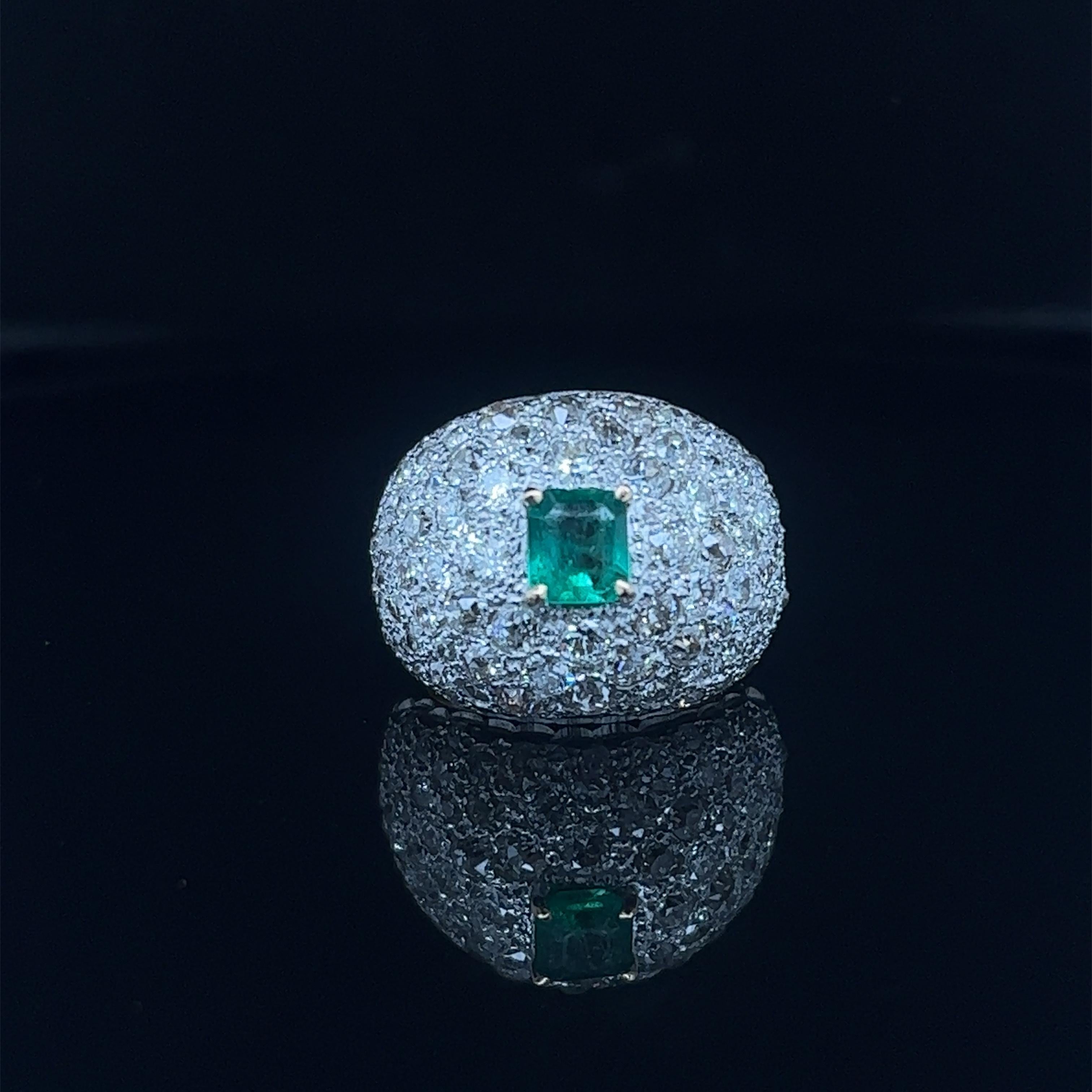     Un design phénoménal pour ce trésor de l'art déco. La bague est électrique car elle met en valeur de vieux diamants de taille européenne qui accentuent une émeraude colombienne d'un vert vibrant. L'anneau a un design en forme de dôme. Il mesure