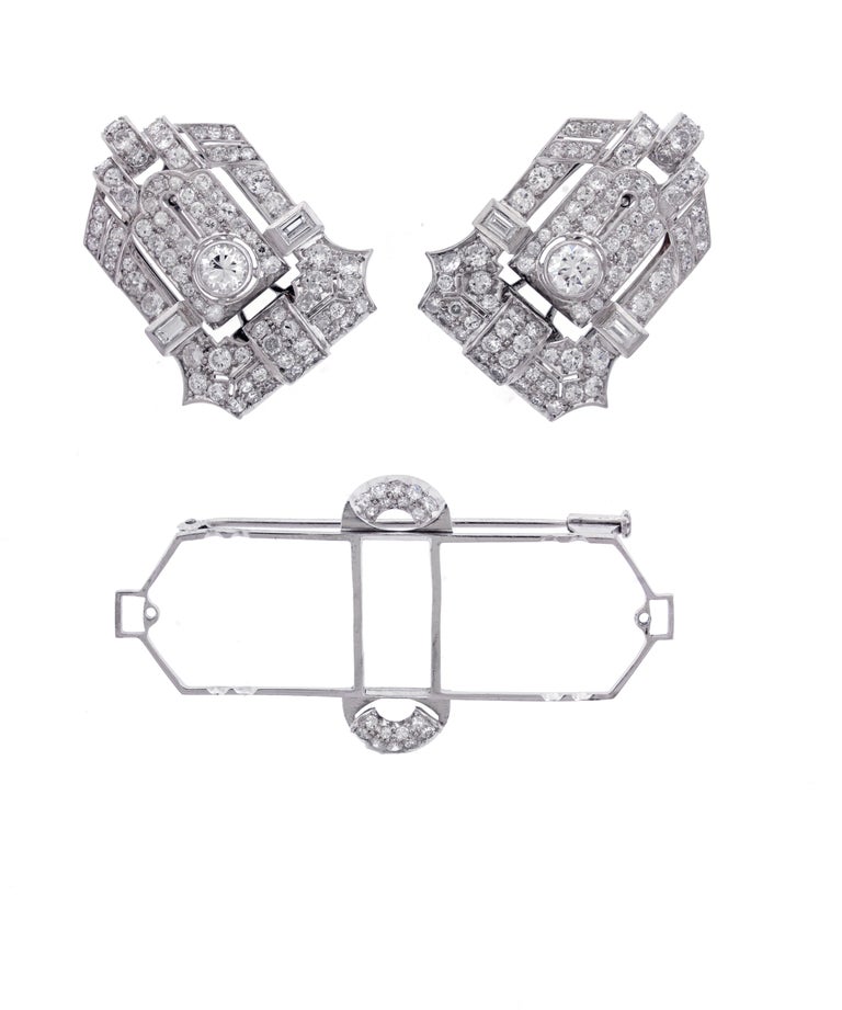 An exquisite example of Art Deco design. This diamond brooch separates to a pair of clips that canbe worn separately or one at a time.
• Metal: Platinum  
• Circa: Early 1930s
• Period: Art Deco
• 2 Old European cut diamonds weigh 1 carat
• 2