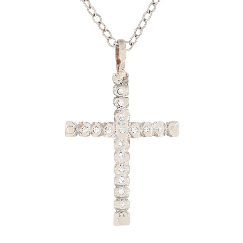 This delicate necklace has 20 grain set diamonds within the cross. The 8-cut diamonds each weigh 0.03 carat, bringing the total to 0.60 carat. They are estimated as G to H and SI in clarity. It has all been made in 18 carat white gold and the chain