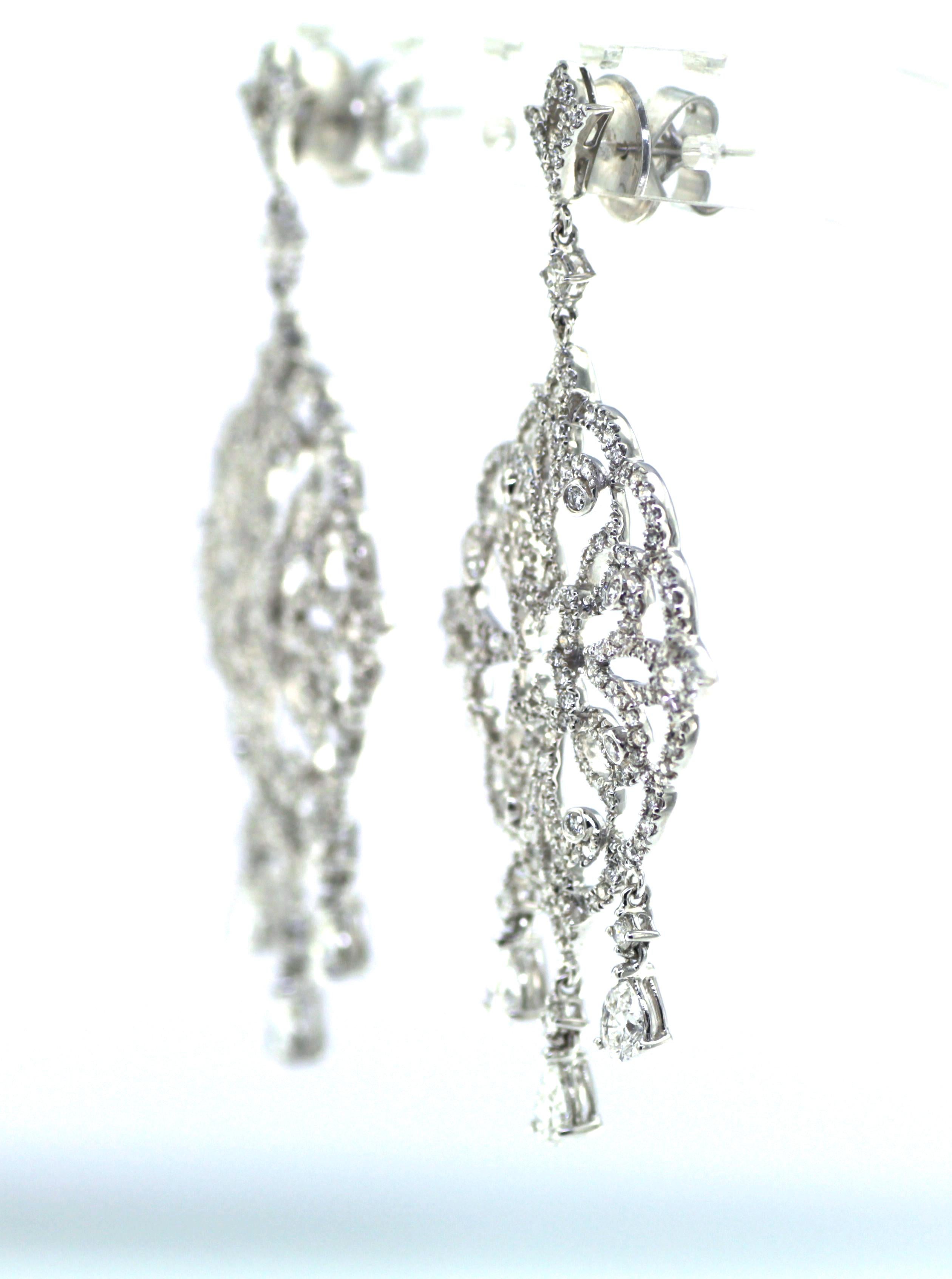 Introducing our captivating Art Deco Diamond Dangle Drop Earrings in 18K White Gold. This vintage-inspired masterpiece exudes elegance and sophistication, making it the perfect accessory to elevate any ensemble.

Featuring a stunning combination of