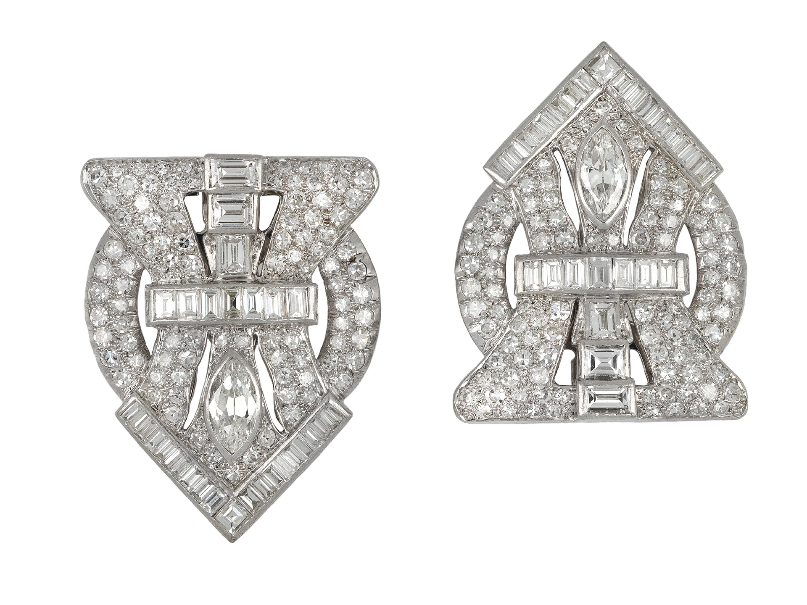 Art Deco diamond double clip brooch. Each set with one marquise shape old cut diamond in an open back rubover setting, two in total with a combined approximate weight of 2.00 carats, additionally set with thirty one rectangular baguette cut and