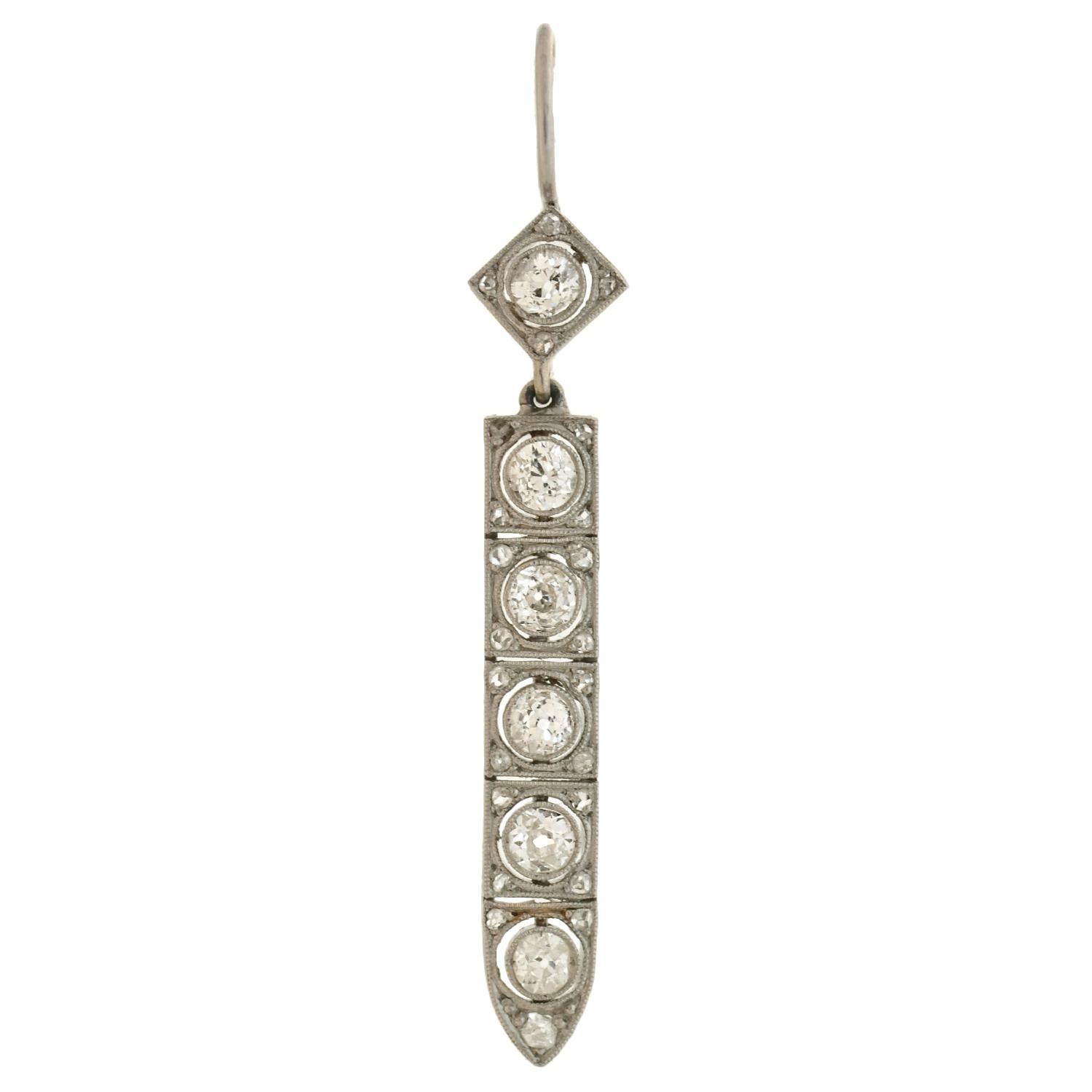 Exquisite diamond earrings from the Art Deco (ca1920) era! Crafted in platinum, these elegant earrings feature dangling links that hang below complimentary surmounts. Each elongated link is lined with 5 sparkling old Mine cut diamonds, which are