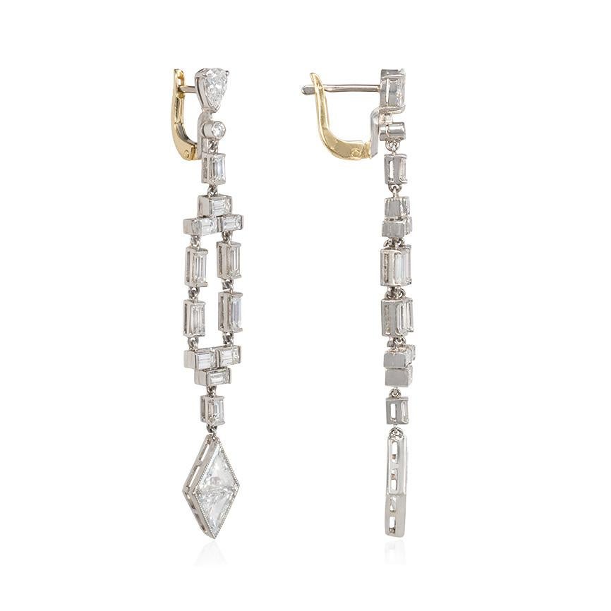 A pair of Art Deco diamond earrings comprised of open baguette frames terminating in kite-shaped pendants, in platinum with 18K gold posts and backs.  Atw 5.00 ct. round, pear, baguette and triangular step cut diamonds