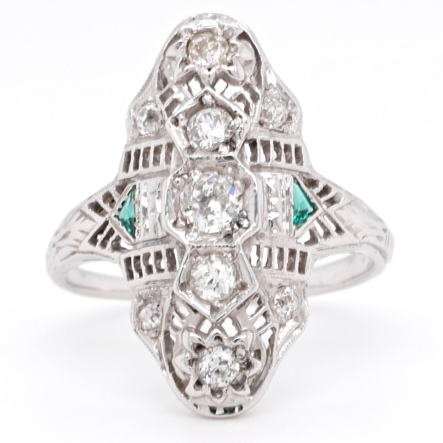 Would you like to own something that is the symbol of an era? And how good would it feel to wear it? This ring is the epitome of Art Deco; symmetry, triangle emeralds, filigree, old European cut diamonds, all of the characteristic of a true period