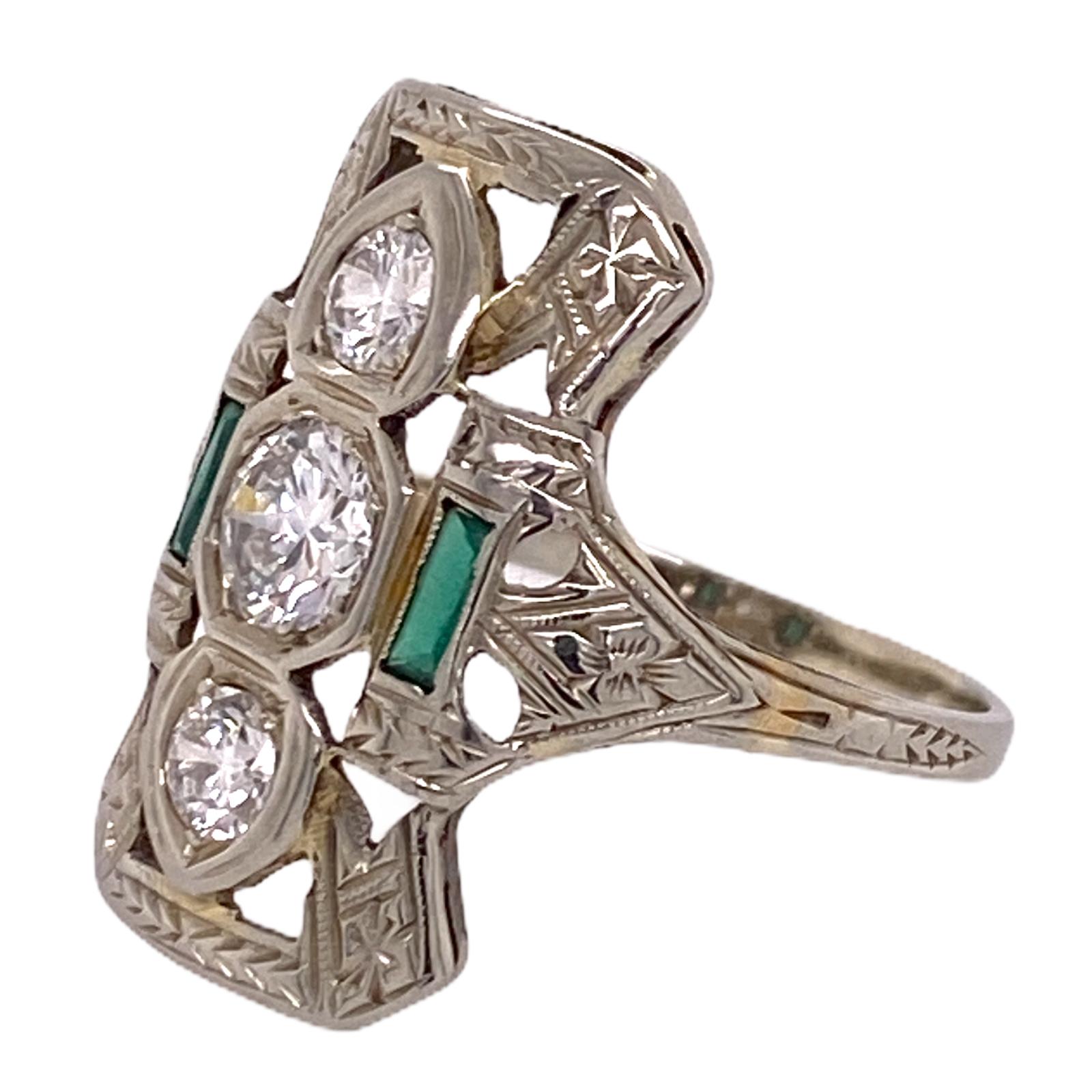 Original Art Deco diamond cocktail ring fashioned in 18 karat white gold. The ring features 3 transitional /Old European cut diamonds weighing .80 carat total weight and graded H-I color and VS clarity. The diamonds are set vertically with emerald