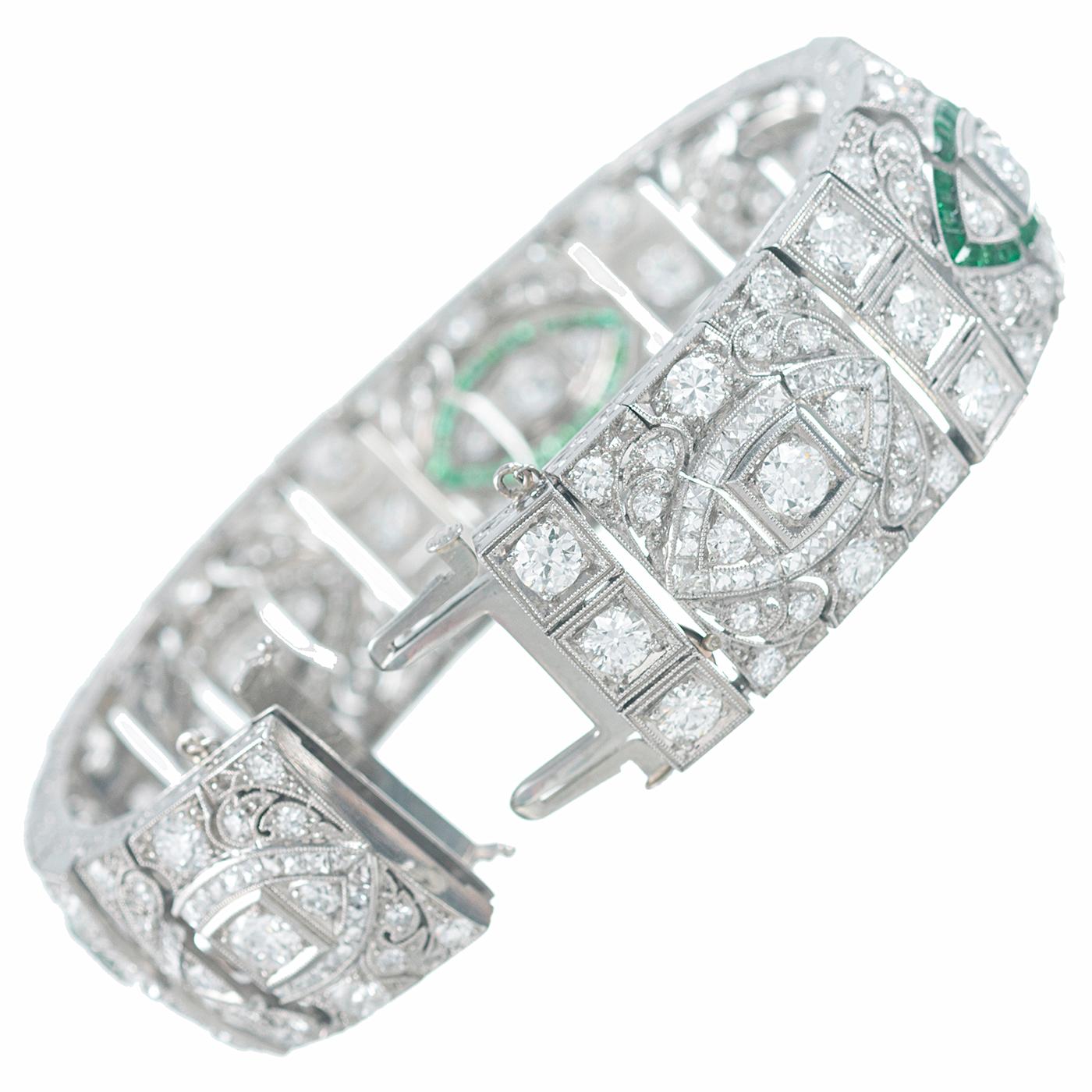 An exceptional example of art deco splendor, this platinum bracelet is adorned with 20 carats of diamonds and accented with marquis-shaped emerald accents. The seven centerpieces of the design resemble eyes and will mesmerize you as you allow your