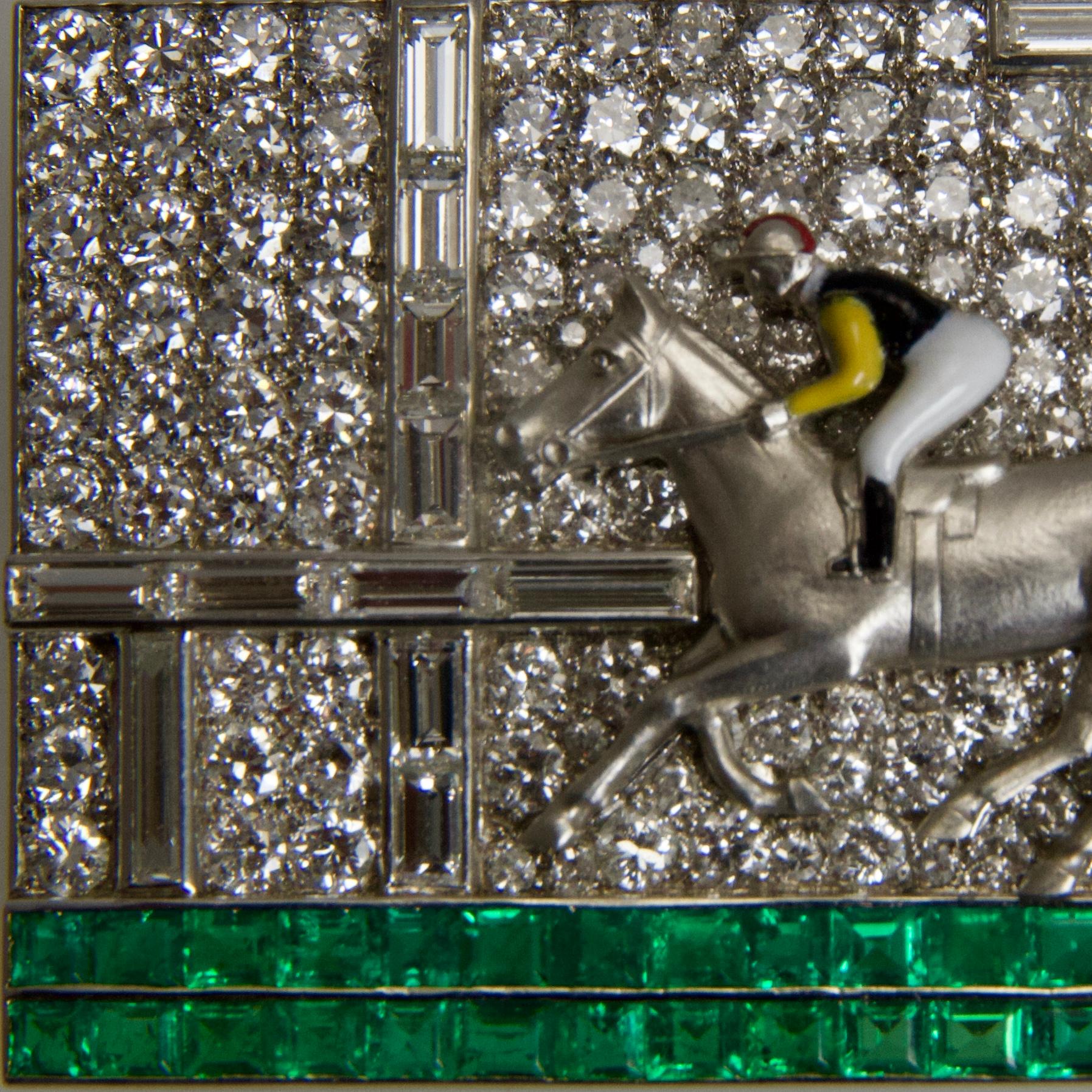 Rectangular brooch in platinum 950 representing a jockey on its horse during a race. 
Body in enamel. Diamonds round and baguettes cut, emeralds calibrés. All in the best quality of this period set, clarity and color of stones, design. 
Diamonds