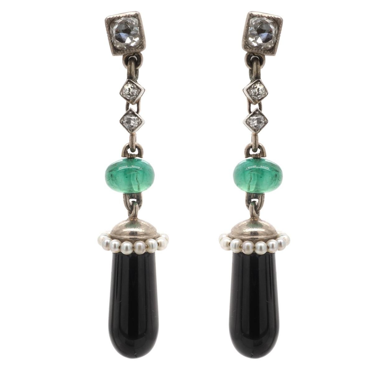 Art Deco Style earrings crafted in 18 karat white gold featuring old mine and swiss cut diamonds with 2 emerald beads 6 x 4mm and 2 black onyx drops 17.0 x 6.4mm.  Weigh 7.4 gr./4.8 dwt. Dimensions L 1 3/4