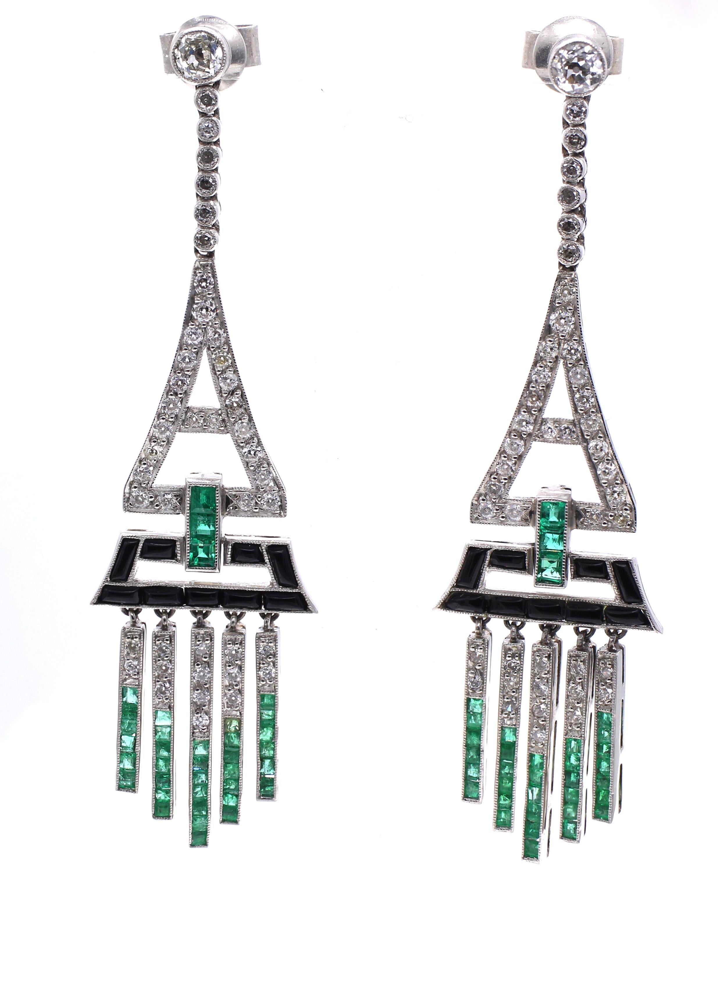 Beautifully designed and masterfully handcrafted these amazing Art Deco ear pendants from ca 1925 are just stunning on the ear. Set in platinum with calibre cut emeralds, buff top onyx and white bright old cut diamonds they bring a unique and