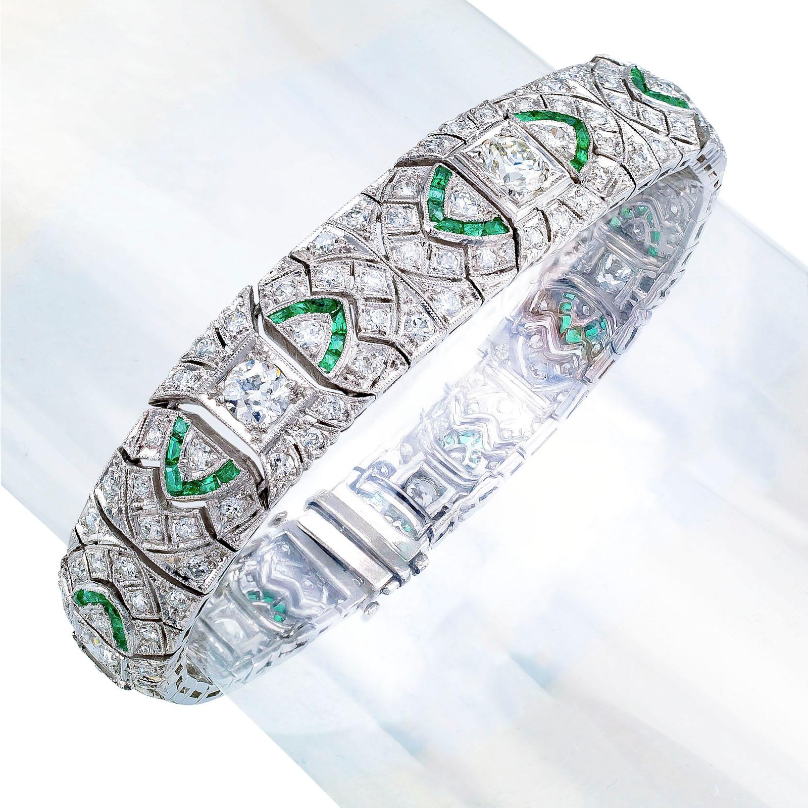 Art Deco diamond emerald and platinum bracelet circa 1925.

DETAILS:
DIAMONDS: one hundred fifty-three old-cut round diamonds totaling approximately 7.00 carats, approximately H – K color, VS – SI clarity.

GEMSTONES: eighty-four calibrated