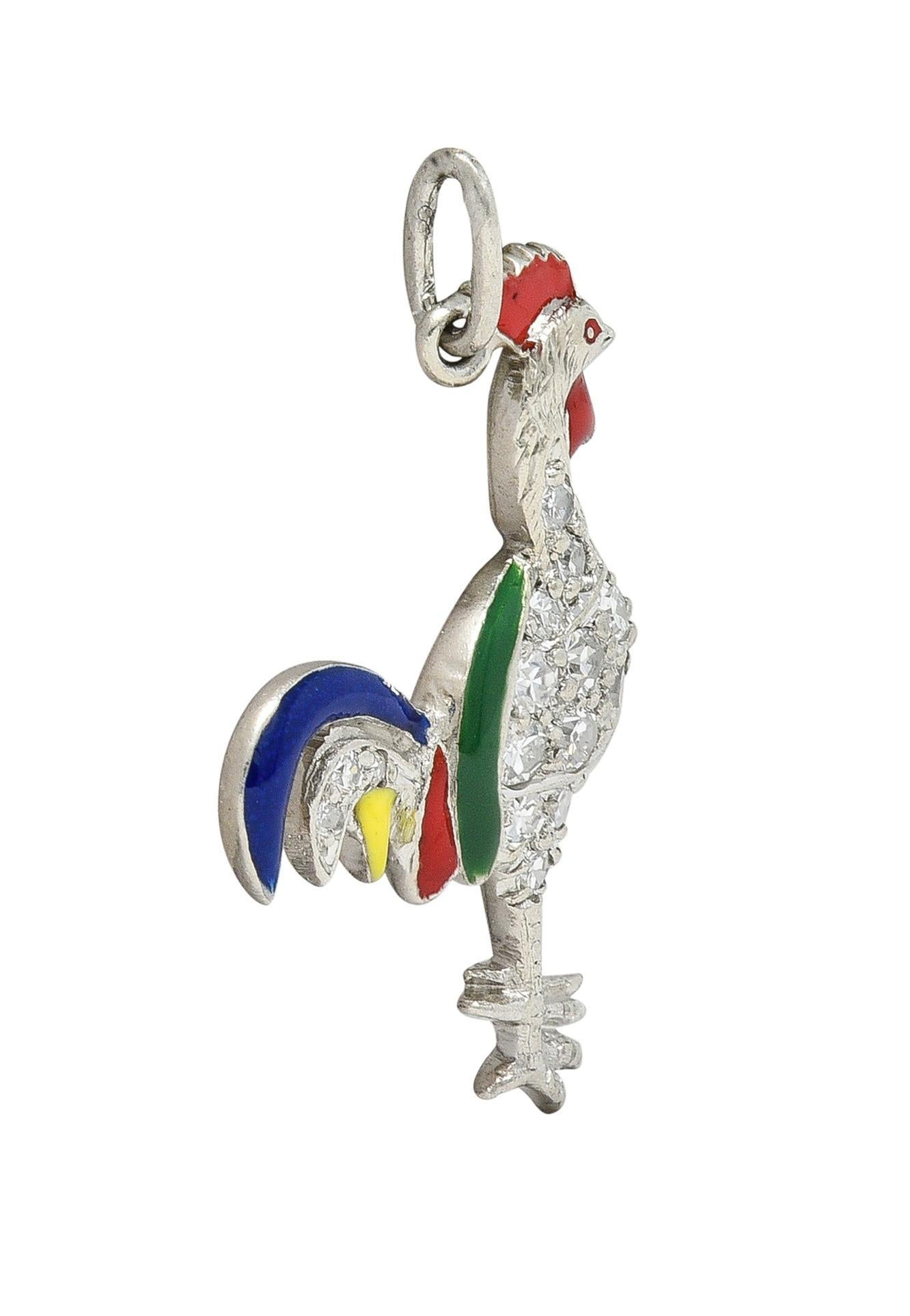 Designed as a stylized rooster with enamel feathers throughout
Opaque glossy red, yellow, blue, and green - minimal loss
With single cut diamonds pavé set throughout body
Weighing approximately 0.20 carat total 
Eye clean and bright 
Completed by