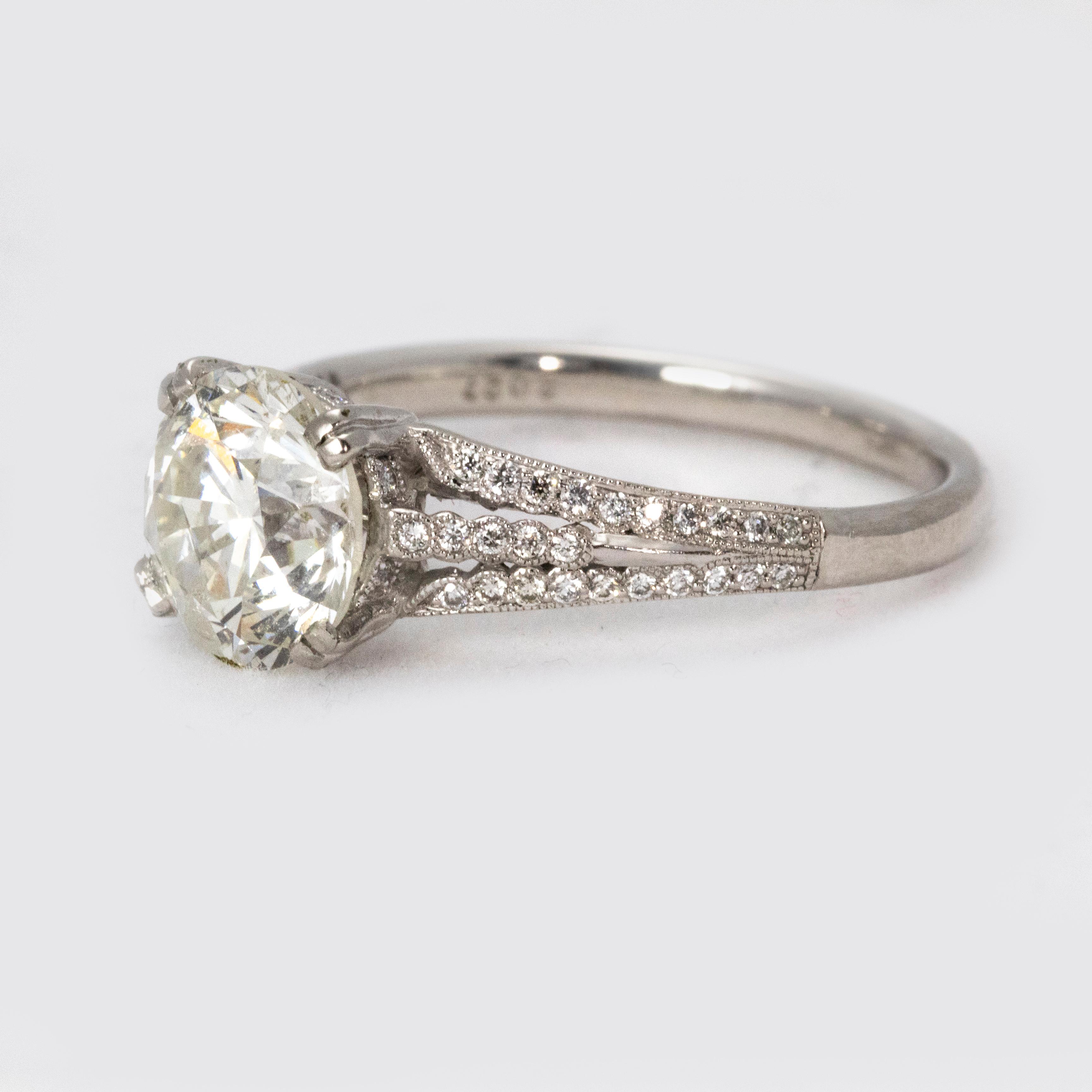 A stunning Art Deco Diamond and Platinum Engagement ring, centred with a old European-cut diamond weighing 2.01 carats, of H colour and clarity SI 2. The shoulders of the ring are intricately adorned with three rows of diamonds, beautifully