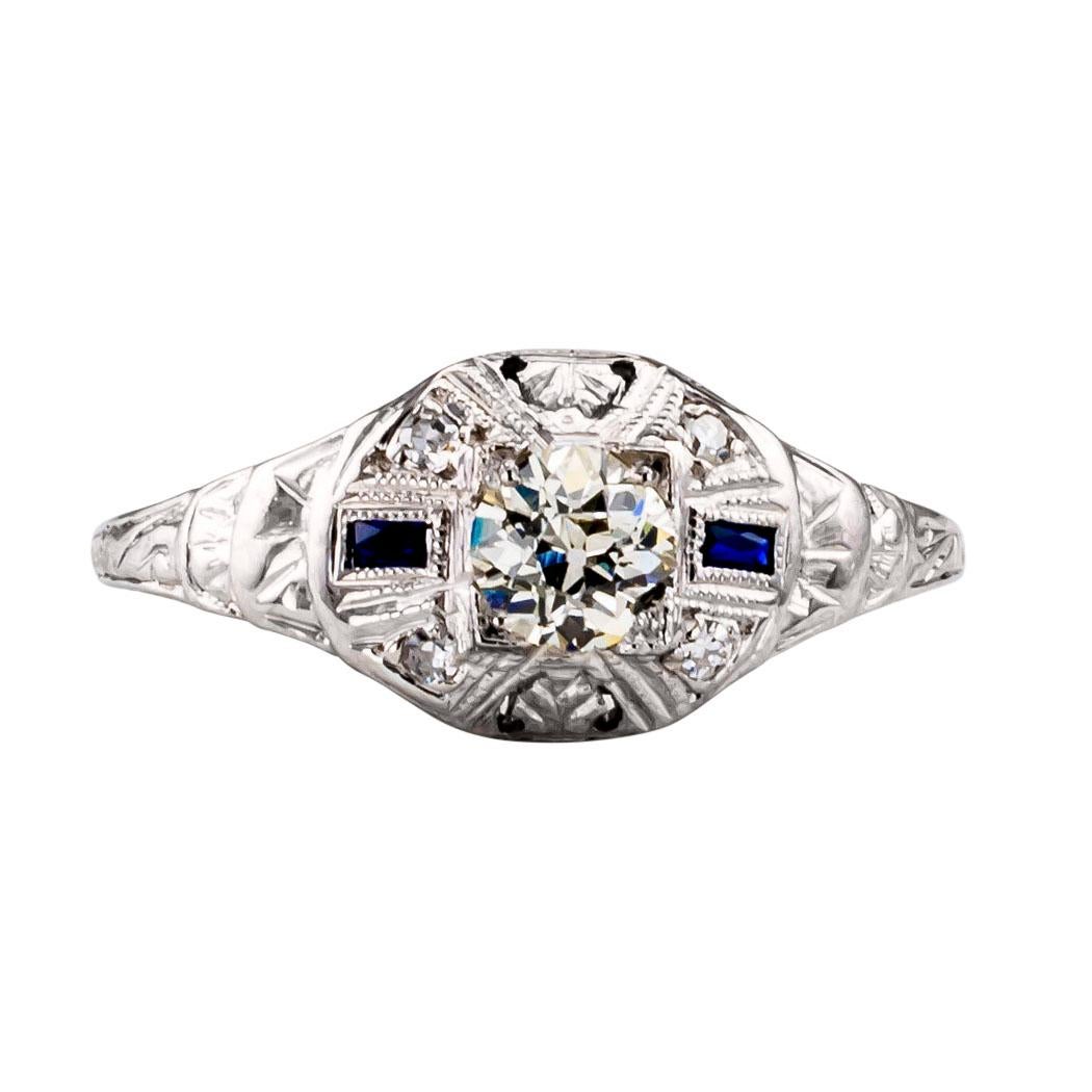 Art Deco 1930s diamond and white gold engagement ring. The petite design centers upon a larger old European-cut diamond, balanced by four smaller round diamonds, together weighing approximately 0.33 carat, approximately M color and VS clarity,