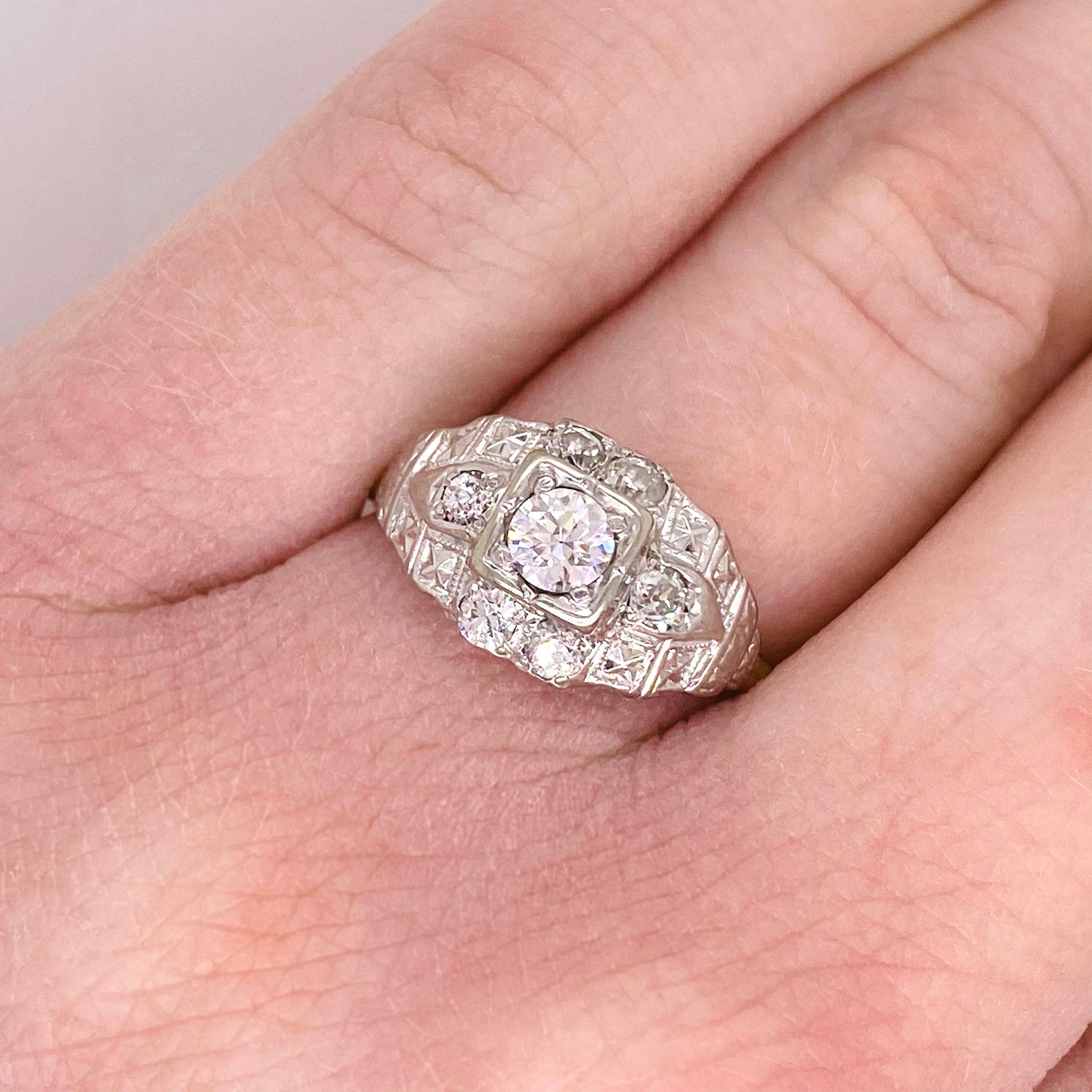 Art Deco Wedding Band is gorgeous with high quality diamonds and a lovely design.  There is a larger diamond in the center with six other accent diamonds.  The top of the ring is handmade in 14 karat white gold and the band (shank) is in 14 karat