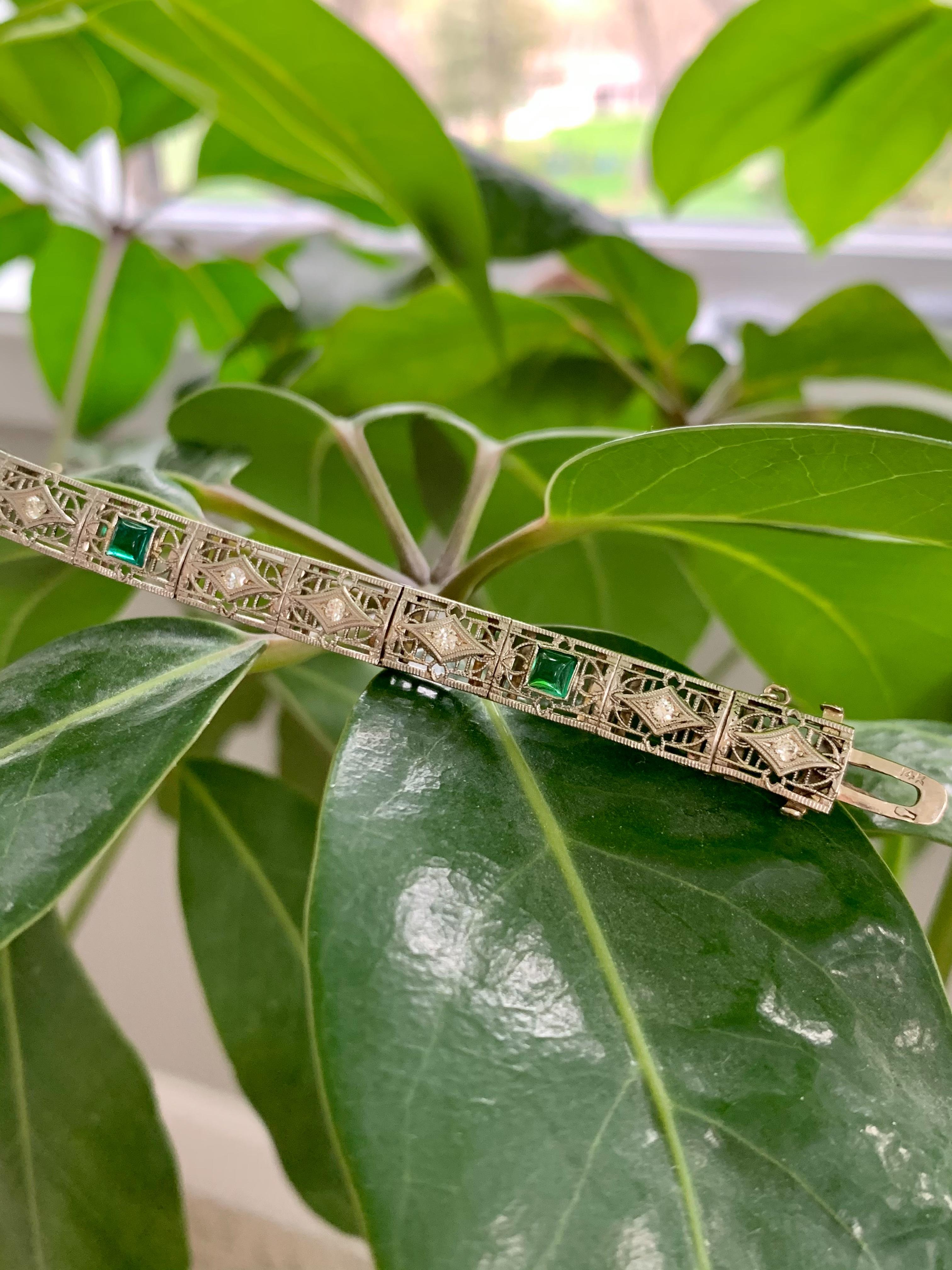 This fabulous, Art Deco 14k white Gold bracelet features 13 brilliant cut Diamonds, which are each approximately 2.3mm in size and weigh approximately .65ctw.  In addition, there are 4-square green glass cabochons which are 4mm each.

Diamond