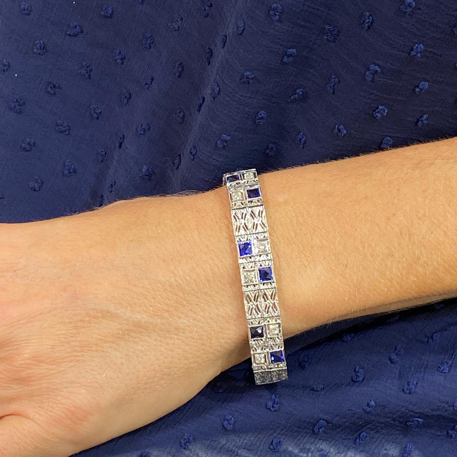  Art Deco Filigree Bracelet crafted in platinum and 18 karat white gold. The 6 Old European Cut Diamonds weigh approximately .90 carats and are graded G-H/VS. Six synthetic blue sapphires, used during that time period, add a nice contrast. The