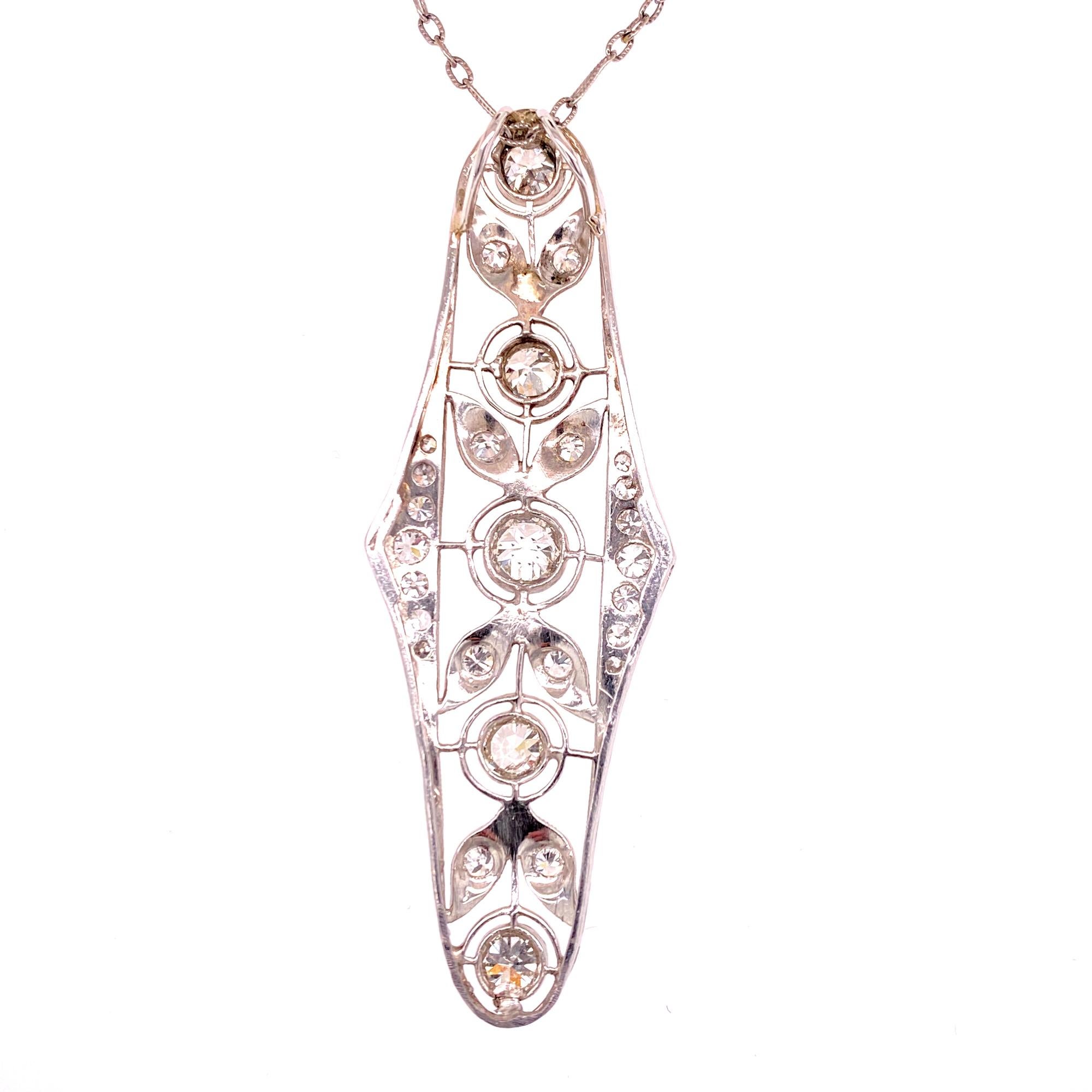 Beautiful original Art Deco diamond filigree pendant necklace. The long filigree pendant features 23 Old European Cut Diamonds (1.75 CTW) graded G-H color and SI1 clarity. The hand crafted pendant is fashioned in platinum and comes on an antique