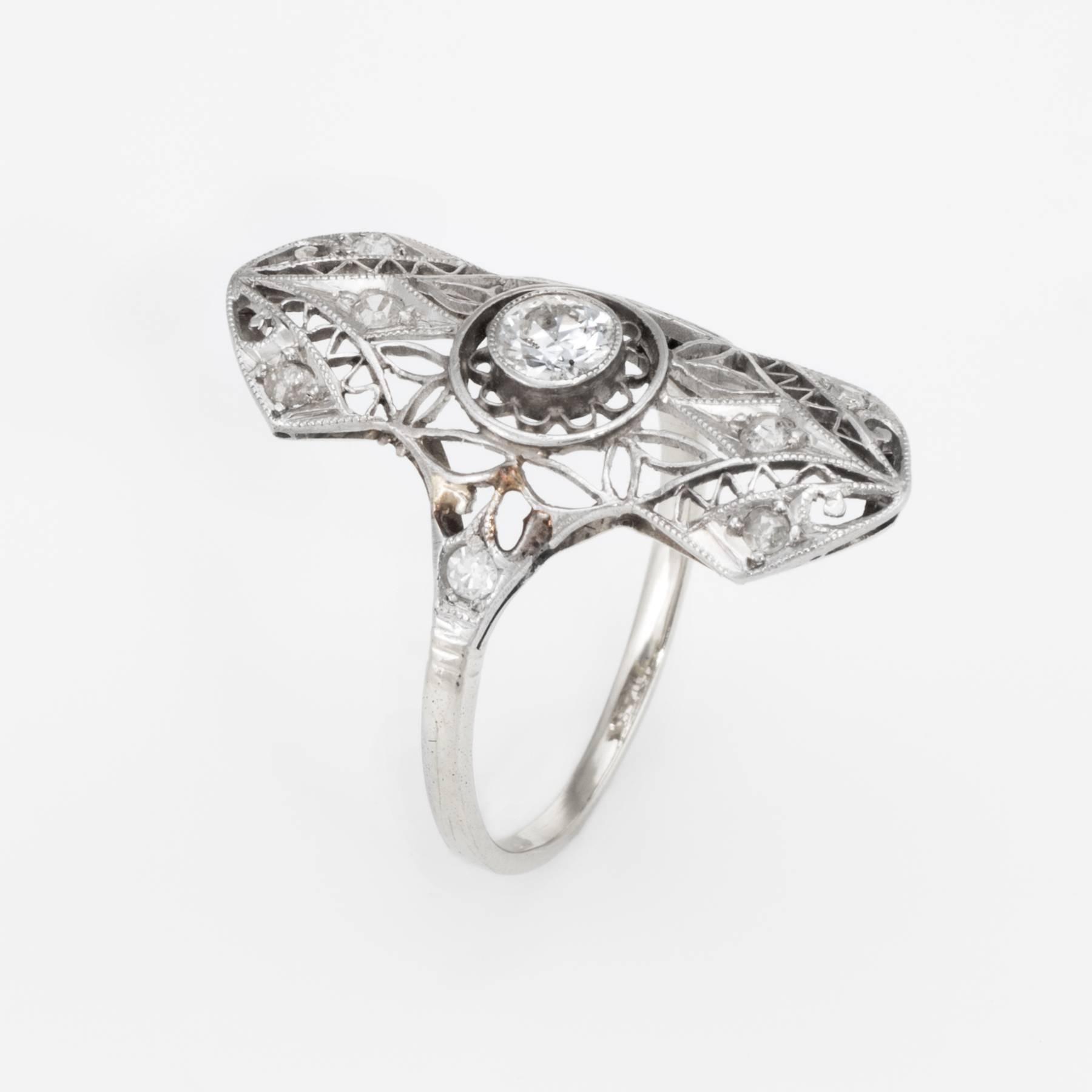 Finely detailed vintage Art Deco era ring (circa 1920s to 1930s), crafted in 14 karat white gold. 

Centrally mounted estimated 0.20 carat old European cut diamond is accented with 8 x estimated 0.02 carat old single cut diamonds. The total diamond
