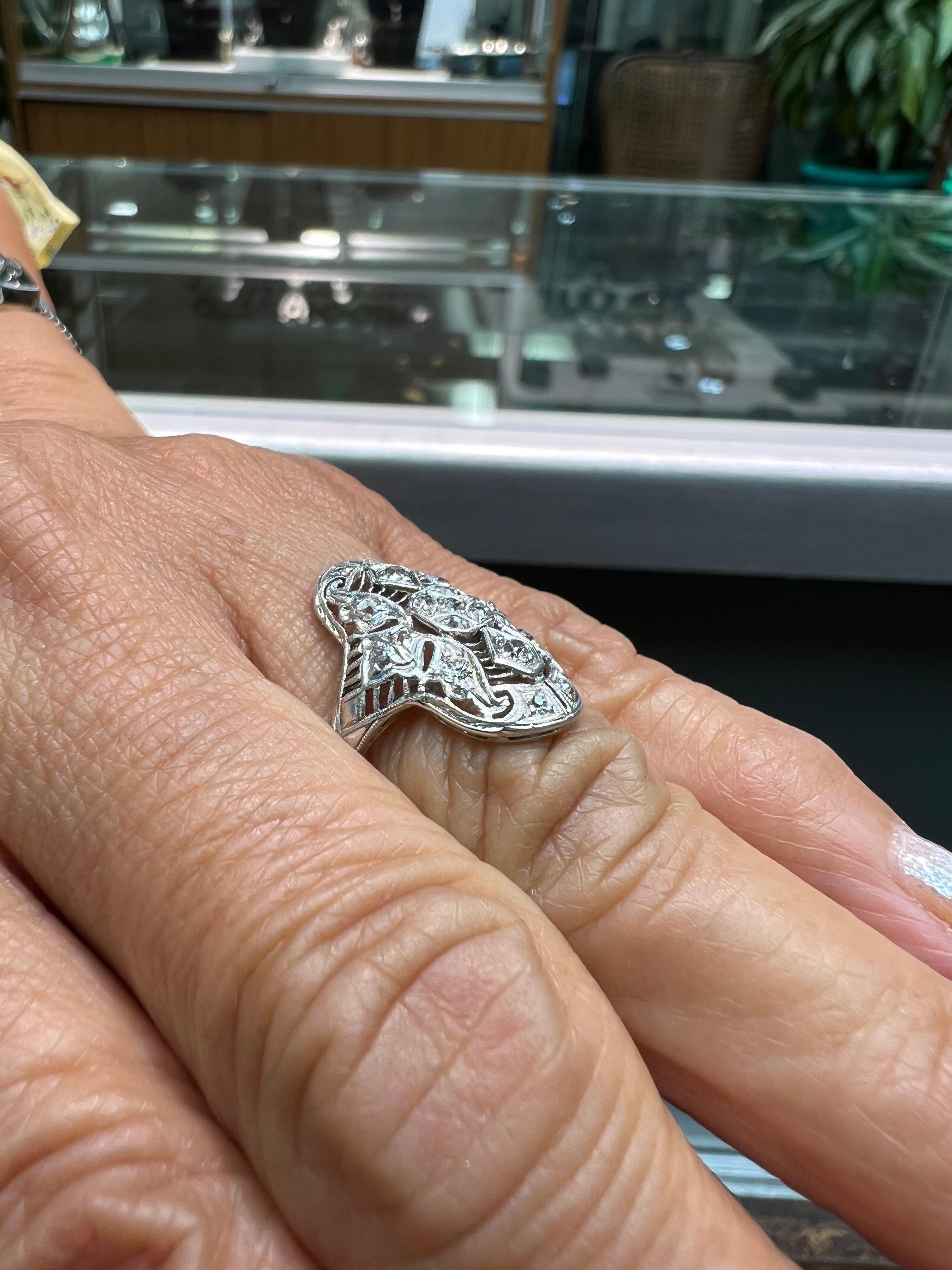  Art Deco diamond filigree dinner ring circa 1925. *

ABOUT THIS ITEM:  #R-DJ629F. Scroll down for specifications.  This is a smaller scale (less than one inch long) Art Deco dinner ring.  The design centers upon a diamond star motif from which