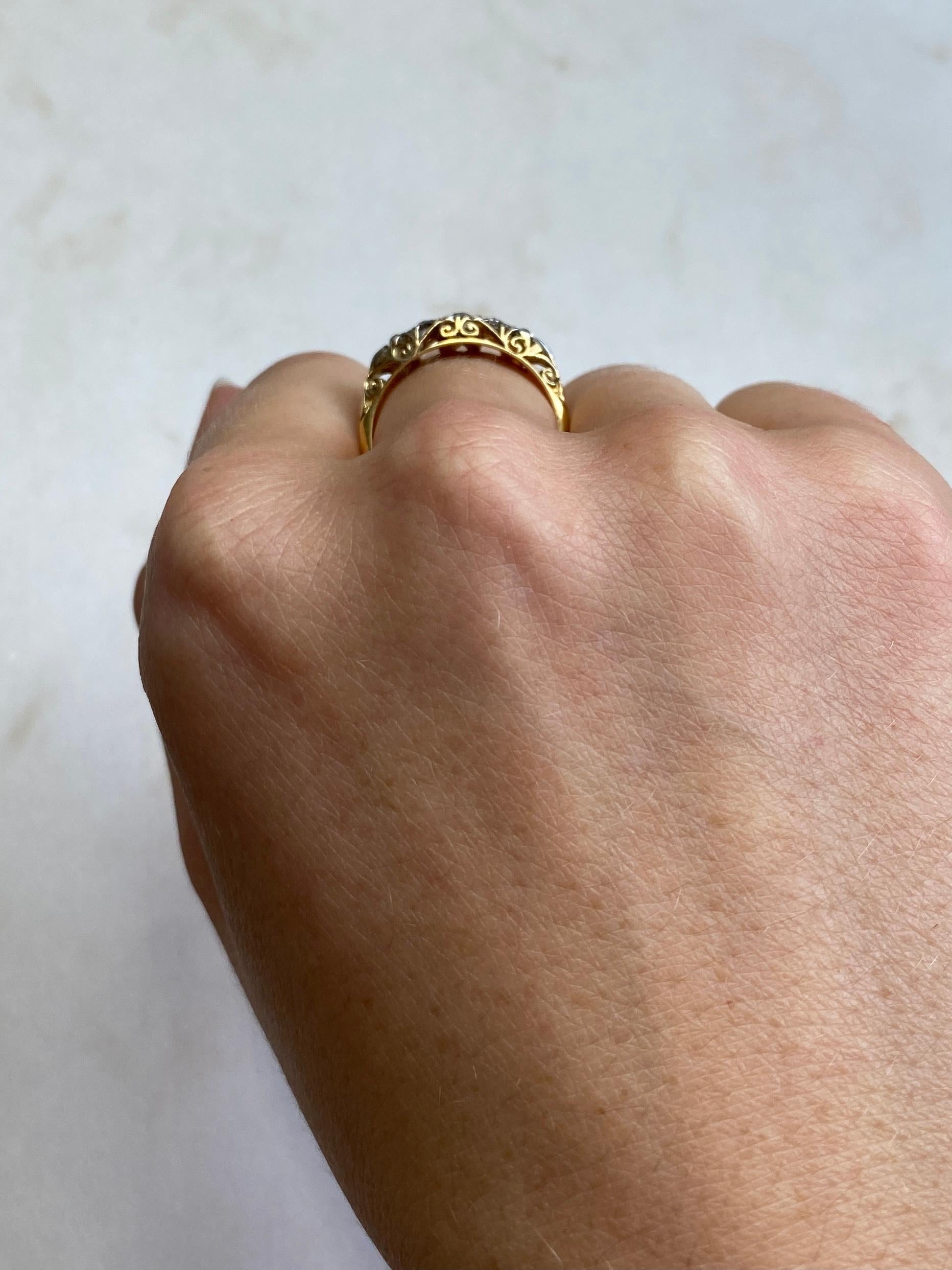 Five glistening diamonds sit fabulously on top of a simple setting modelled in 18ct gold. The diamond total is 50pts. 

Ring Size: P or 7 1/2 
Width: 5mm
Height Off Finger: 4mm

Weight: 2.86g