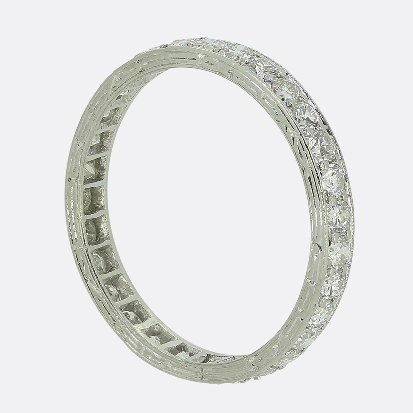 Here we have a delightful eternity ring dating back to the early stages of the 20th century. This platinum piece features 26 round single cut diamonds; each of which has been individually claw set amidst a fine milgrain bordering above and below.