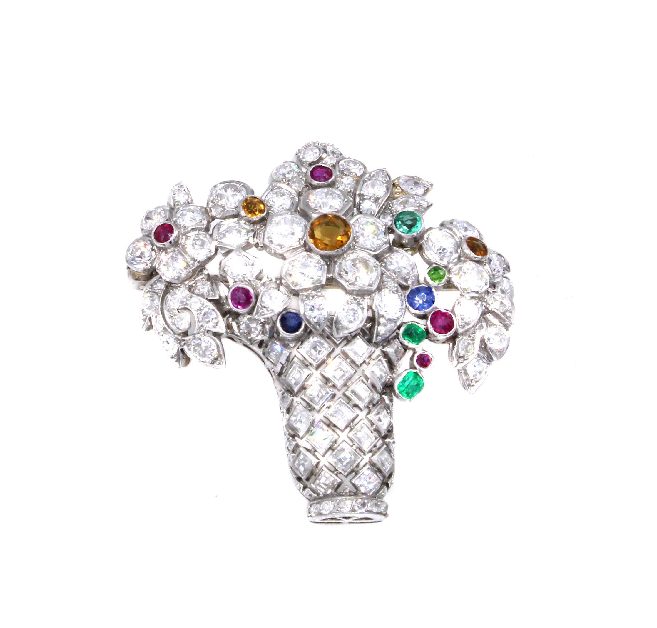 Beautifully designed and masterfully hand-crafted this Art Deco Jardinière brooch from ca 1925 is set with a mixture of bright white and sparkly Old European Cut diamonds and square step-cut diamonds. The bouquet of floral motifs are embellished