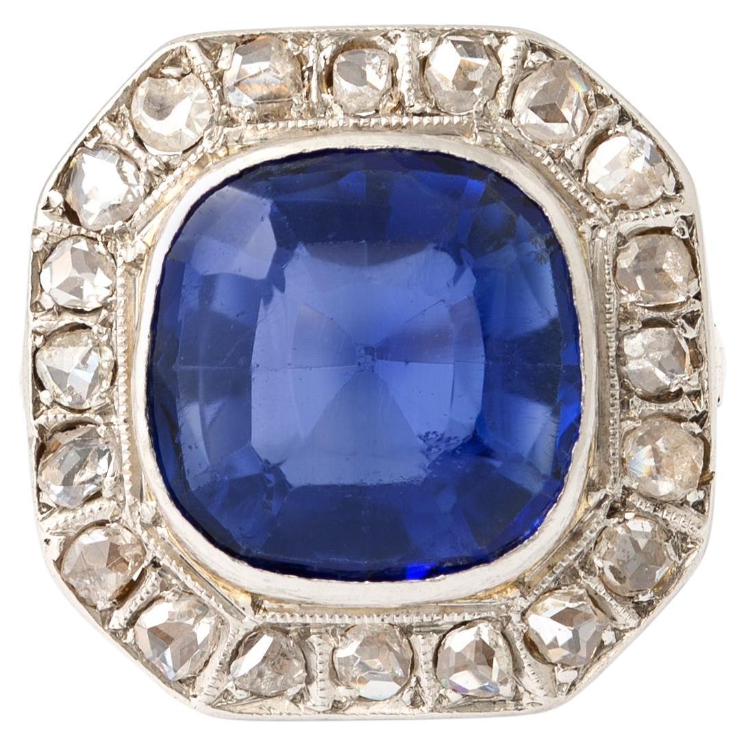 18K yellow and white gold ring centered by a cushion shape synthetic sapphire.
Approximately estimated to be 5.00-6.00 carats, surrounded by rose-cut diamonds.
Sapphire dimensions: 10.70 x 10.35 x 6.19 mm.
Circa Mid-20th Century
Gross weight: 4.17