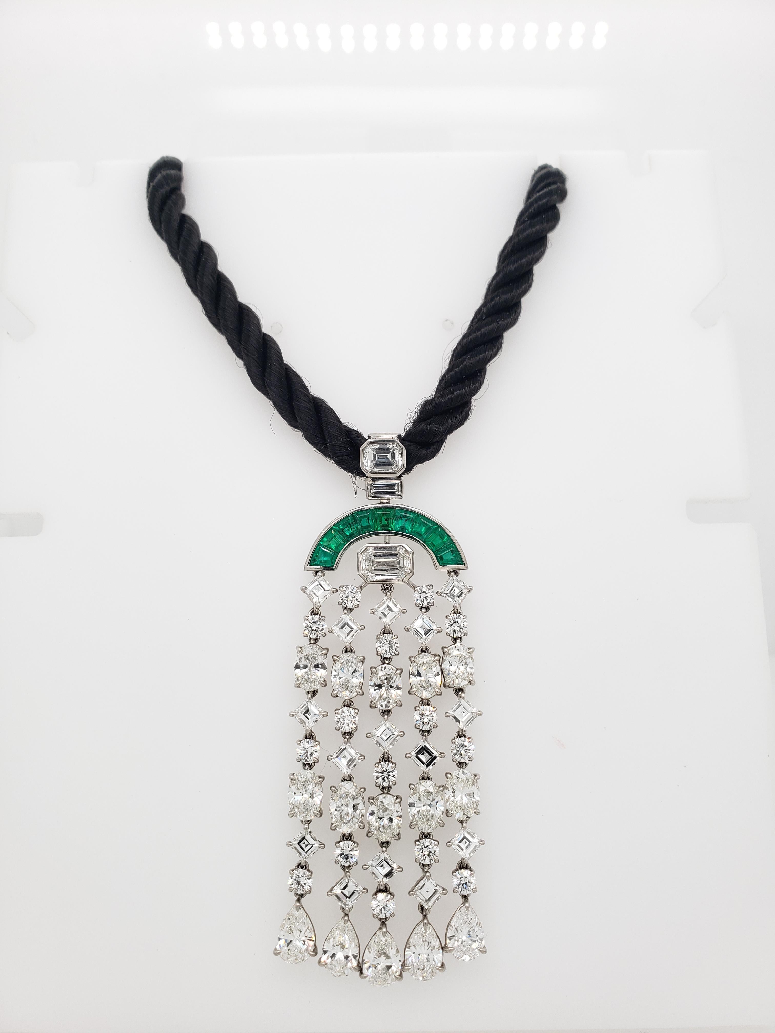 This one of a kind Art Deco Diamond and Emerald Tassle Necklace contains 40 Emerald Cut, Pear, Oval, Round Brilliant Cut, Square Emerald Cut, and Baguettes of collection diamonds colored from D to G. Total Diamond weight is approximately 10.75