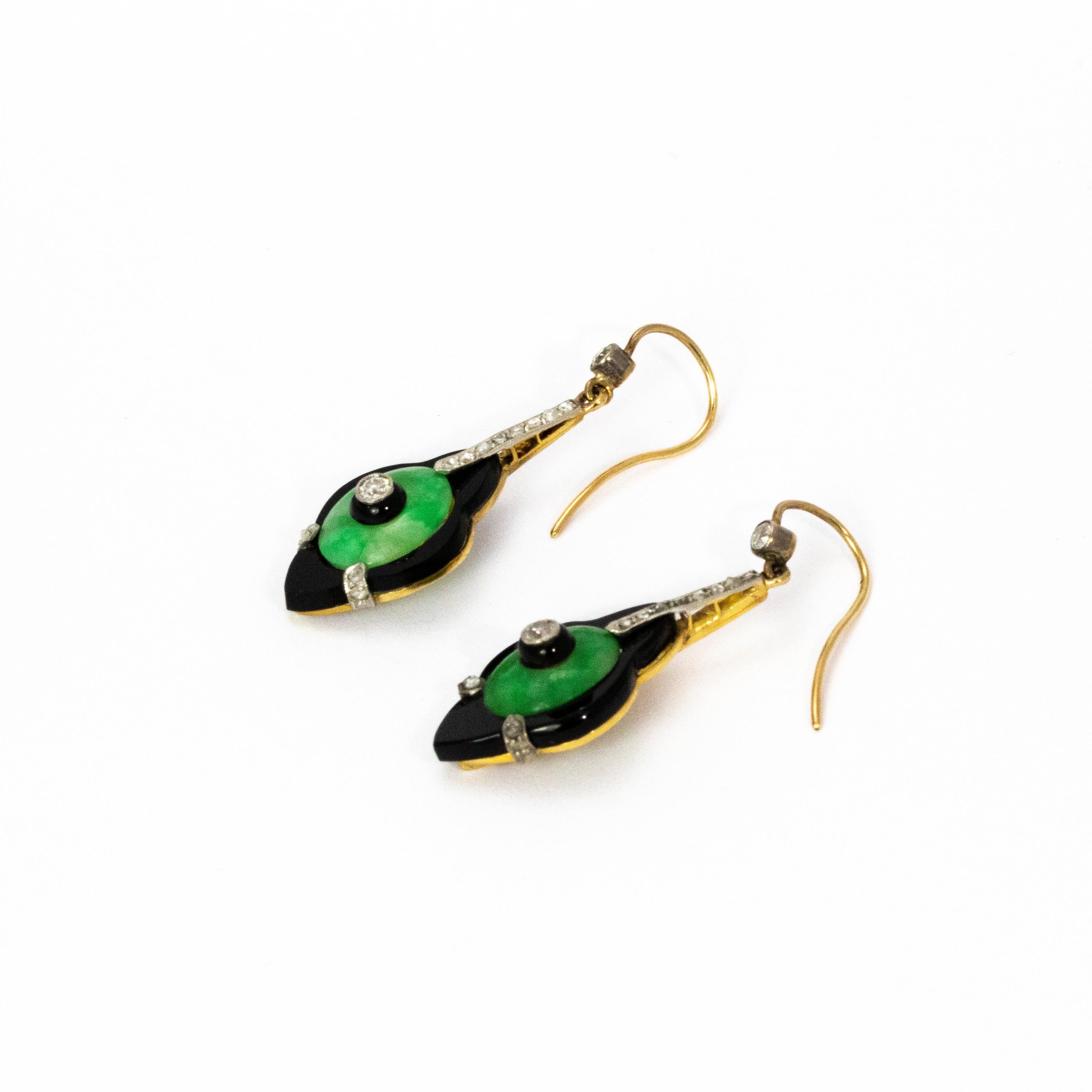 A fantastic pair of Art Deco drop earrings. The central diamonds are old mine cut and measure approximately 5 points each, these sit inside a jade cabochon which itself is surrounded by black onyx which brilliantly accentuate its colour. Modelled in