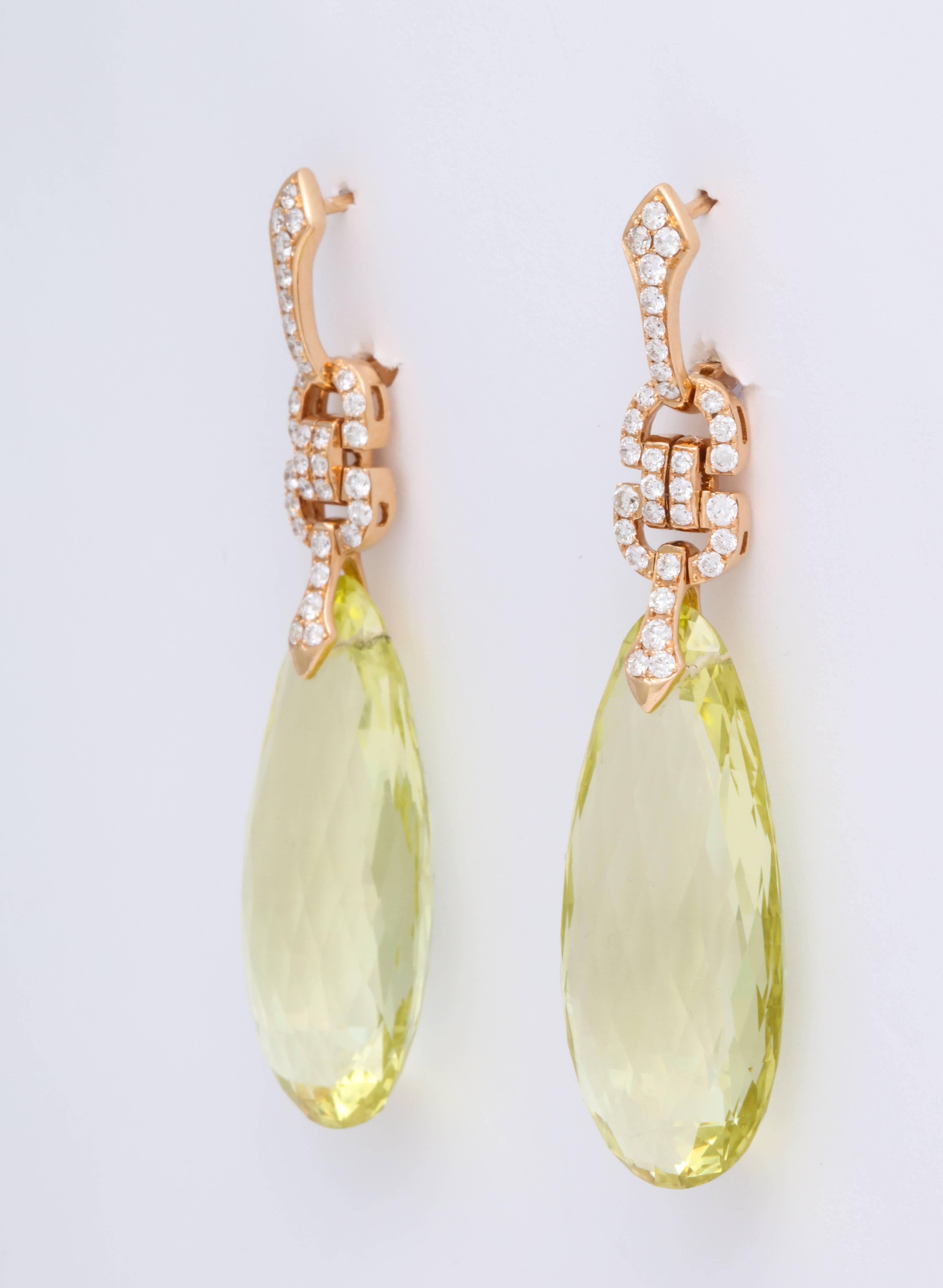 Swinging lemon quartz briolette pendants weighing 52.58 carats suspended from stylized art-deco motifs decorated with round brilliant cut diamonds weighing 0.85 carats set in 18K rose gold.