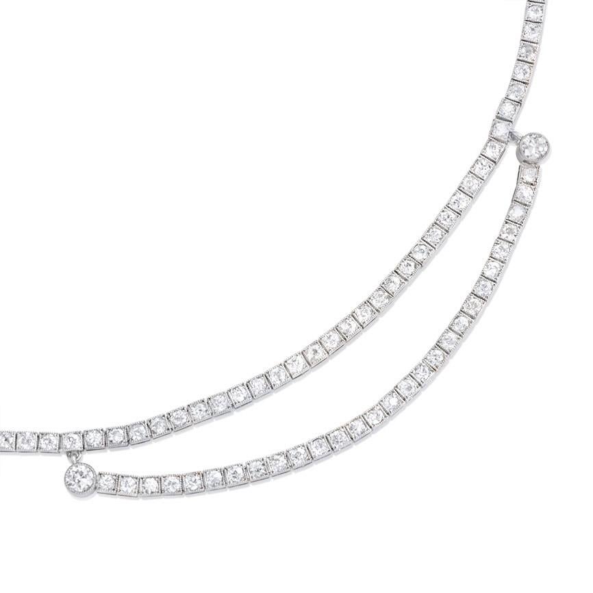 An Art Deco diamond line necklace with a swag center, in platinum.  France.  Atw 4.00 cts.