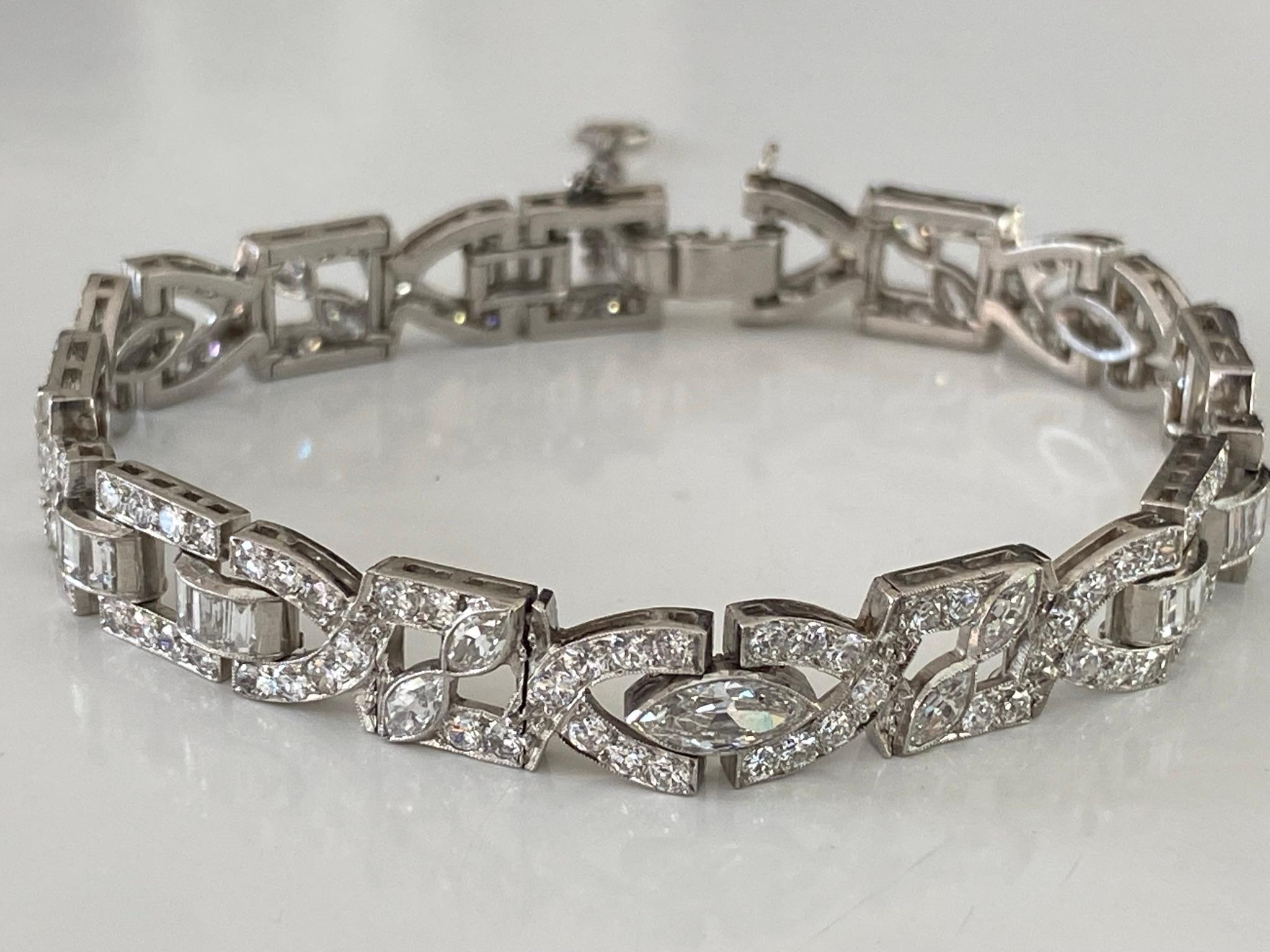 This dazzling Art Deco link bracelet fashioned in platinum is designed around a sparkling array of Old European cut, marquise and baguette diamonds with delicate milgraining throughout. The total diamond weight measures 7.50 carats, G-H color, VS