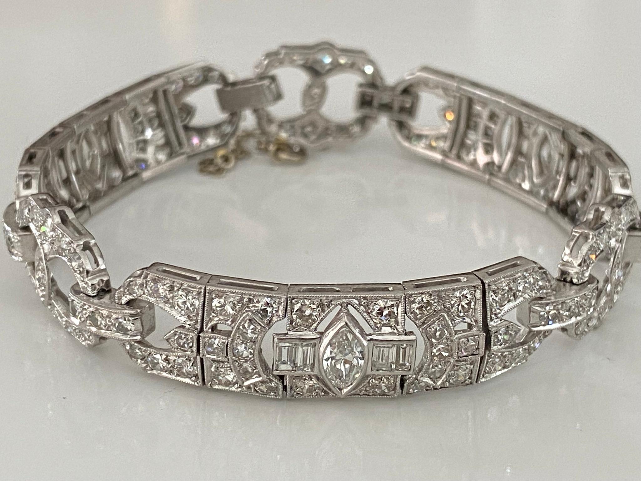 This dazzling Art Deco link bracelet fashioned in platinum showcases a glistening array of Old European cut, single cut, marquise and baguette diamonds totaling approximately 9.00 carats, G-H color, VS-SI clarity. Circa 1930s, with a 14kt white gold