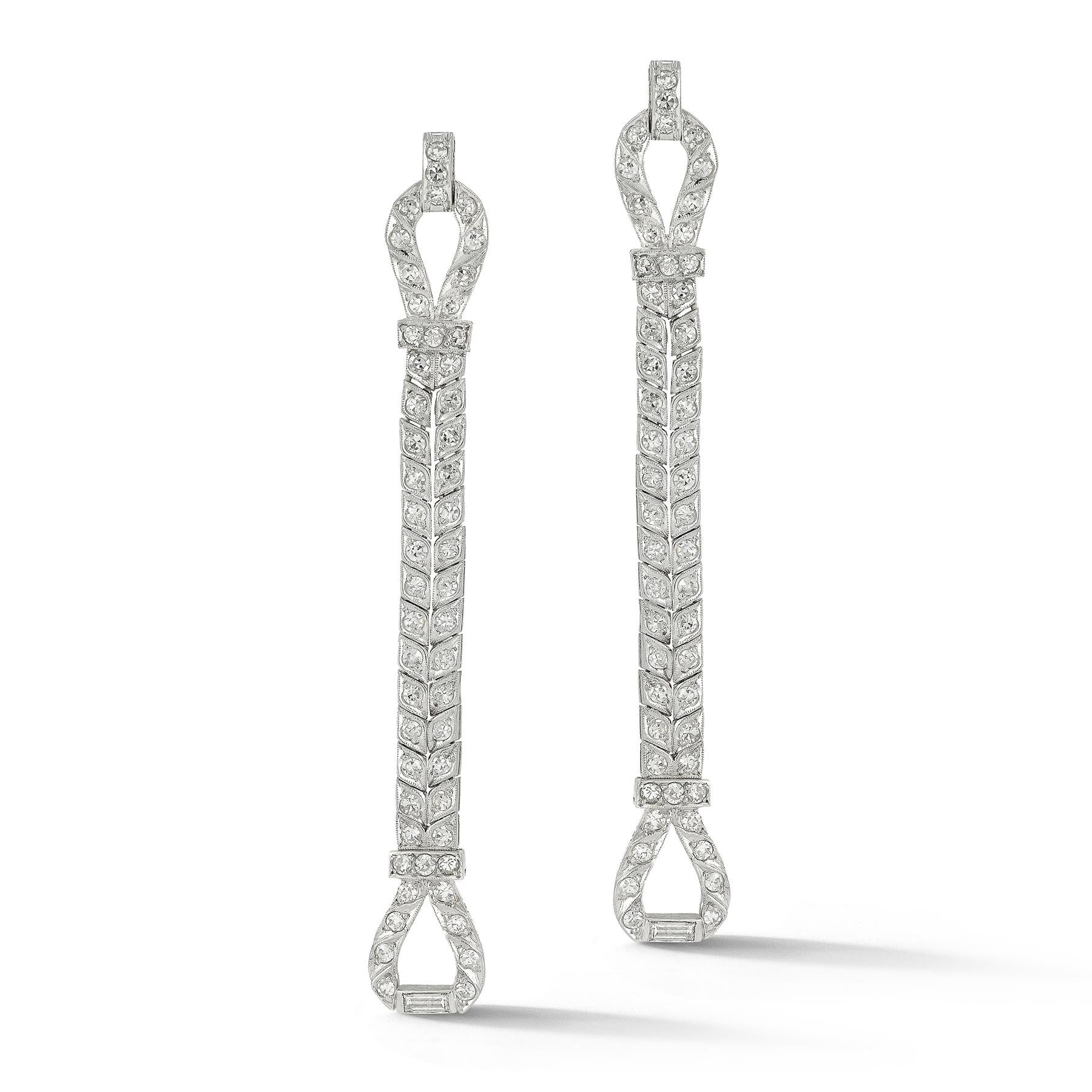 Art Deco Diamond Loop Earrings 

Two rows of  53 round & 2 baguette cut diamonds weighing approximately 3.10 carats set in platinum.

Measurements: 2.75