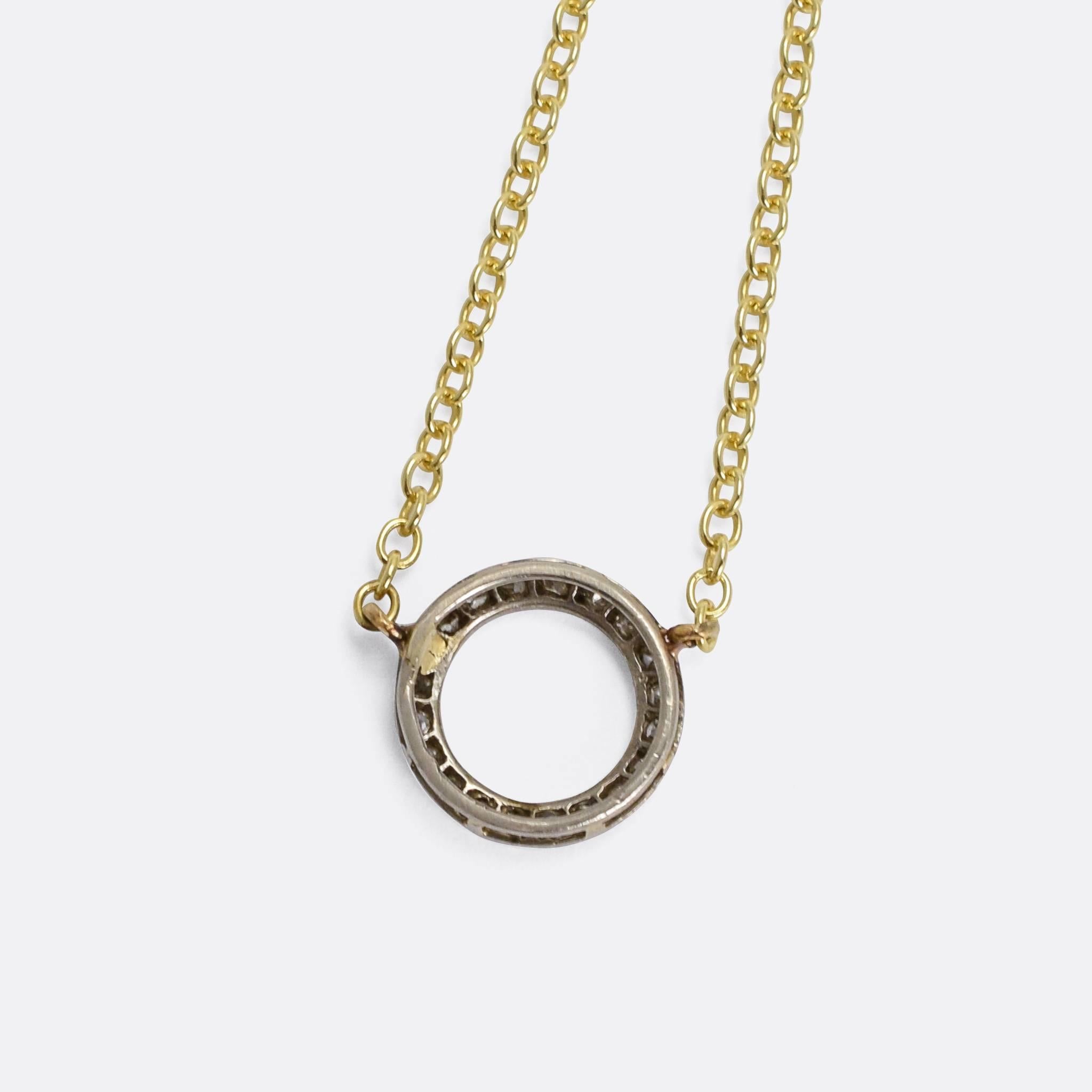 A stylish and unique Art Deco era pendant necklace, the head modelled as a diamond-set halo and finished in fine platinum millegrain. Originally a stick pin, we have added a 9k gold chain converting the piece into a very wearable necklace.

STONES