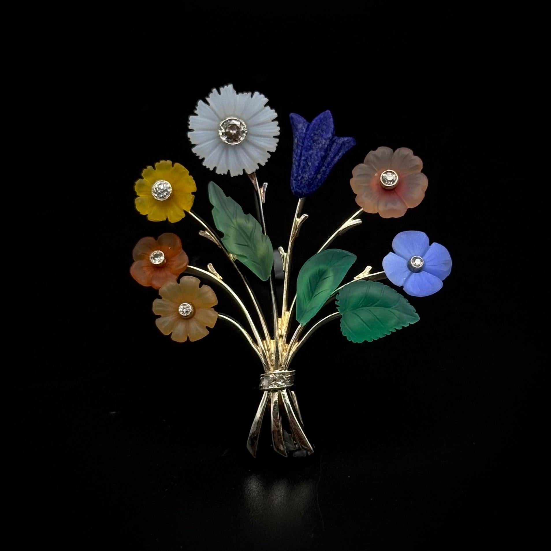 Art Deco diamond and multi-gem floral bouquet brooch in white gold, Czechoslovakia, 1930s. Designed as an elegant floral bouquet, the diamond-set flowers are delicately made with carved lapis lazuli and multi-color chalcedony, the polished white