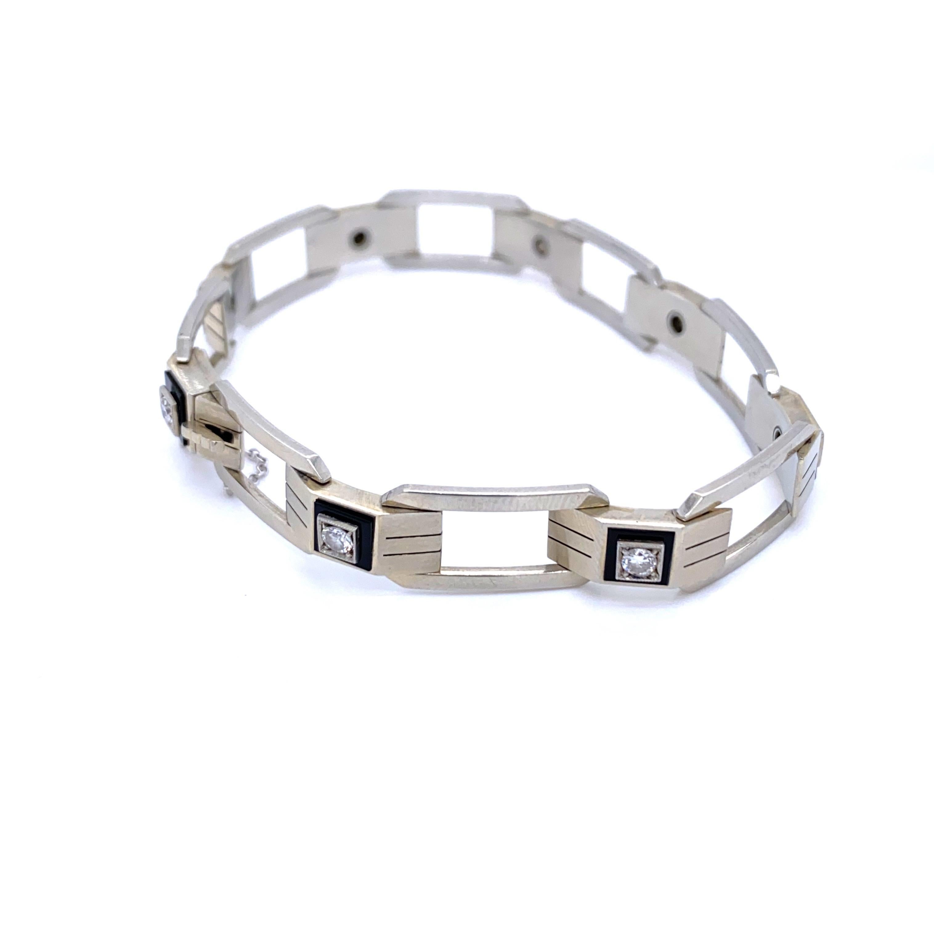 Classic Art Deco character in this unusual and rare link bracelet. It features 7 Round cut Diamond, totaling approximately 1.10 carats G color Vvs Clarity, framed in a custom cut Onyx square, all set in solid 18k white Gold.
Safety chain and lock