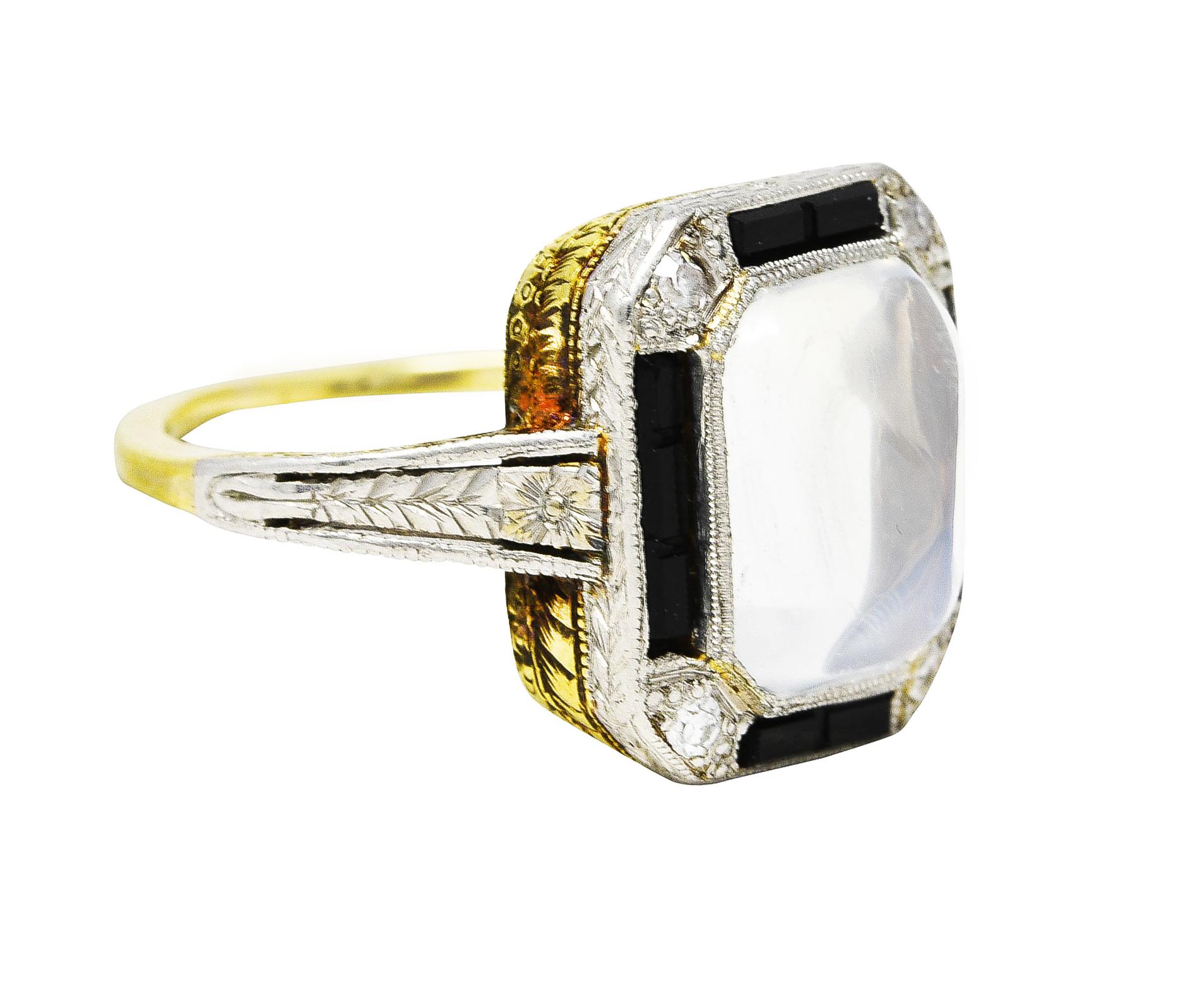 Octagonal head ring centers a 7.0 x 9.5 mm sugarloaf shaped moonstone cabochon weighing 2.43 carats. Translucent with colorless body and vivid blue adularescence - set in platinum milgrain bezel. Featuring a halo surround of channel set baguette cut