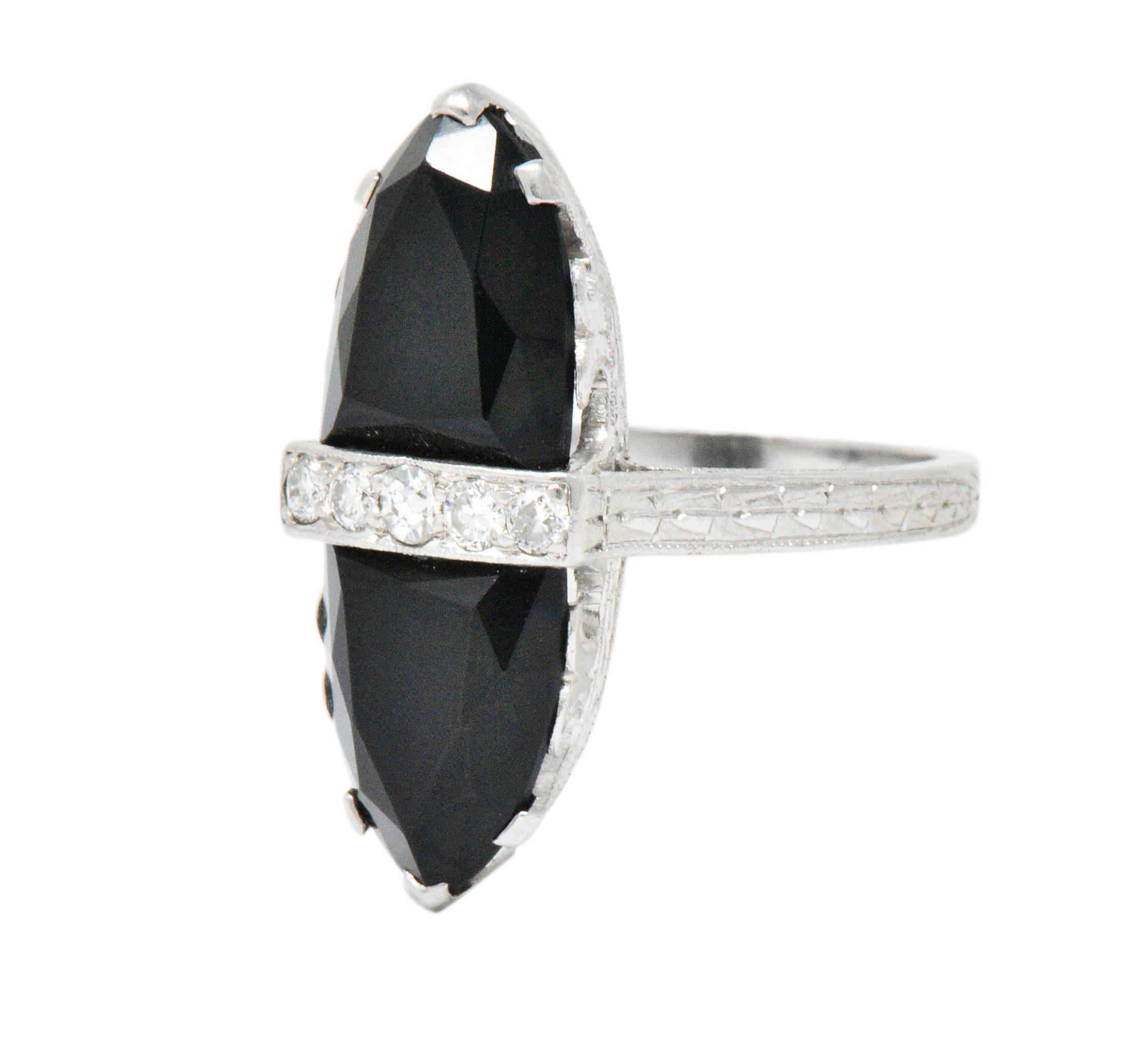 Centering 5 old European and single cut diamonds, weighing approximately 0.10 carat total, eye-clean and white 

With two faceted rounded triangle onyx measuring 9.6 x 7.4 x 2.5 mm, 9.2 x 7.6 x 2.6 mm, respectively

In a stunning scrolling