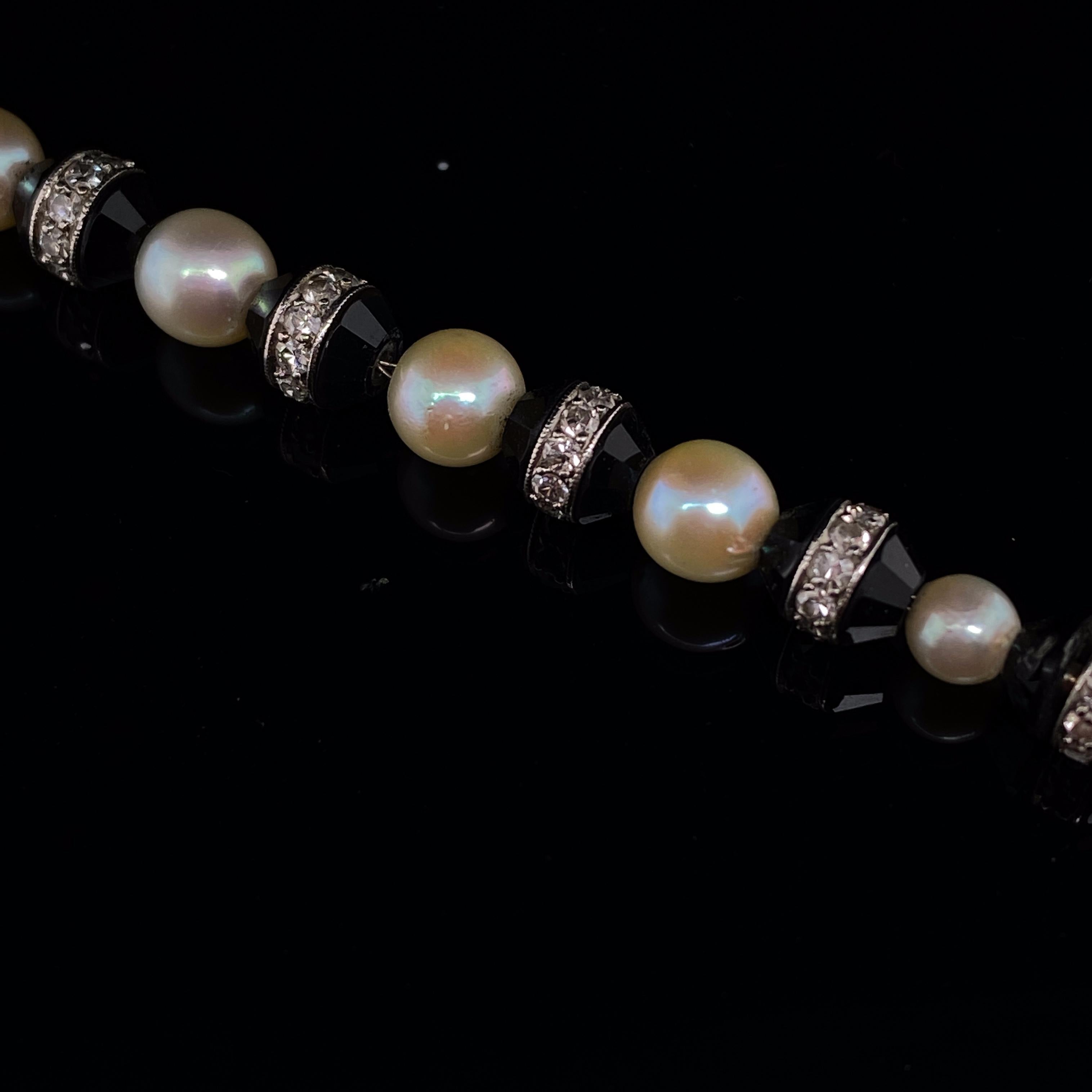 An Art Deco diamond, pearl and onyx platinum bracelet.

A beautiful example of a classic Art Deco bracelet, with cultured pearls interspaced onyx and diamond beads.
All diamonds are pave set into a fine strip on each faceted onyx bead.
These beads