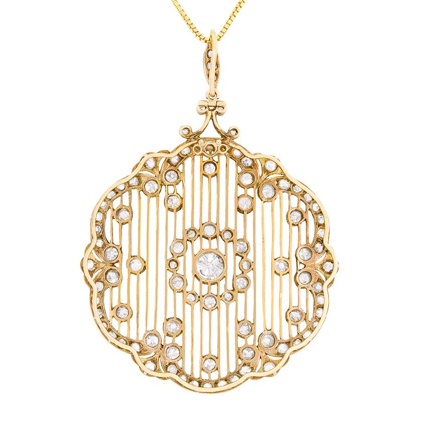 This handmade pendant is also a brooch and comes with detachable pin. It features a flower design of rub over set old cut diamonds. In the centre of the pendant, the stone weighs 0.80 carat and the surrounding halo and motifs measure 4.80 carat in