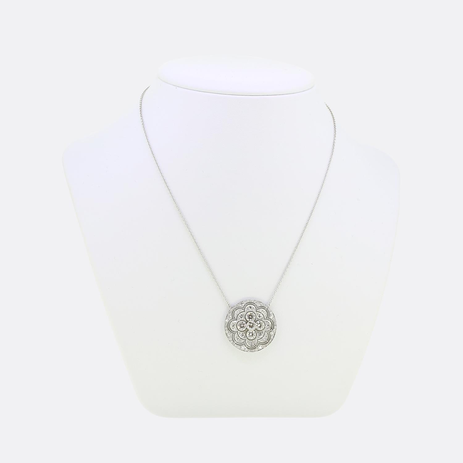 Here we have a delightful diamond necklace taken from the Art Deco movement. This geometric pendant has been crafted from platinum into a circular shape and features five round faceted transitional cut diamonds at the centre. The backdrop