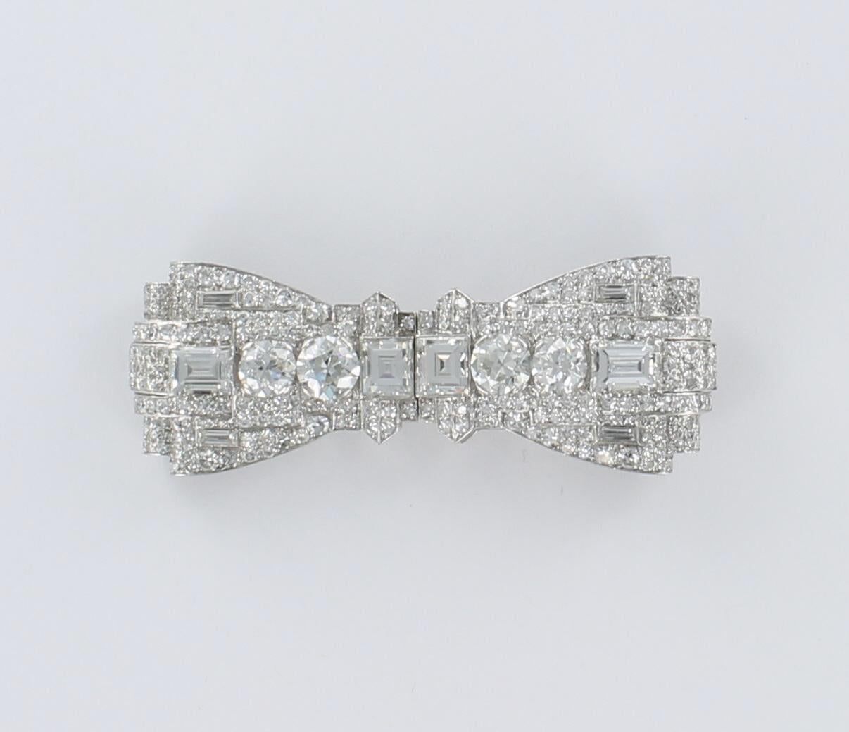 This magnificent platinum pin is from the Art Deco period.  There are 13.50 carat total weight of diamonds including emerald cut, round brilliant, asscher cut, pave-set and baguettes.  While its primary use was that of a pin, the pin comes apart