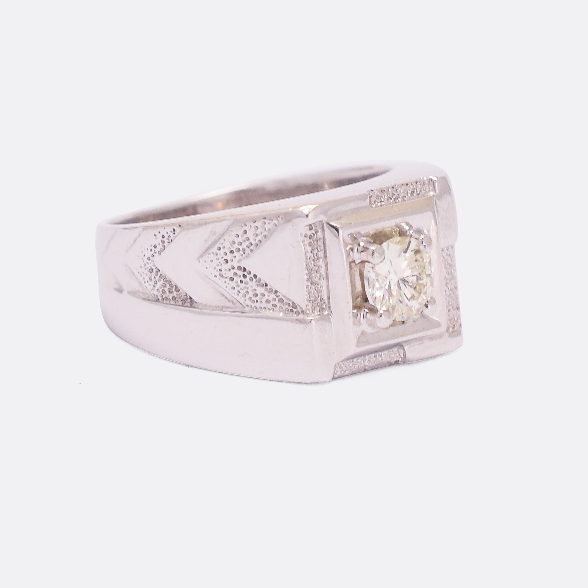 A cool Art Deco era pinky ring with textured chevron details to the shoulders and set with a single brilliant cut diamond. It's modelled in 18k white gold, platinum set, and dates from the 1930s.

STONES 
0.35ct Brilliant cut diamond - approx. VS2