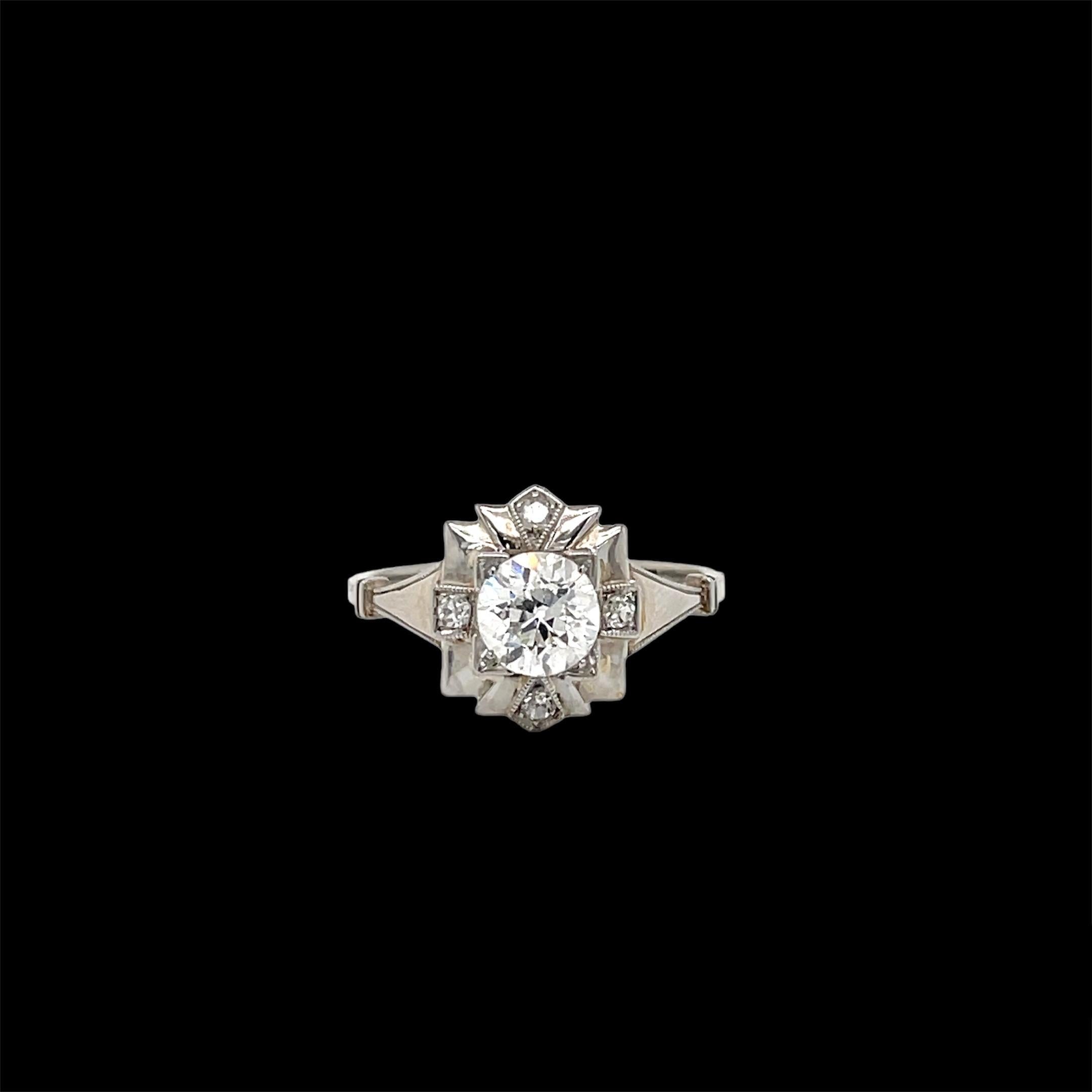 An exquisite Art Deco ring, hand-crafted in 18k white gold, authentic from 1930, featuring in the center sparkling Old European cut Diamond weighing .90 carat, surrounded by 0,10 carats of smaller diamonds.

The ring is original in every part,