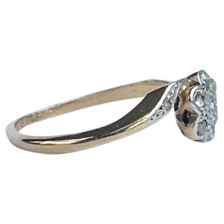 This gorgeous panel holds small yet very sparkly rose cut diamonds set in platinum and the rest of the ring is modelled in 18 carat gold. The diamond total of this ring is 23pts. 

Size: K 1/2 or 5 1/2  
Cluster Diameter: 7mm

Weight: 2g

